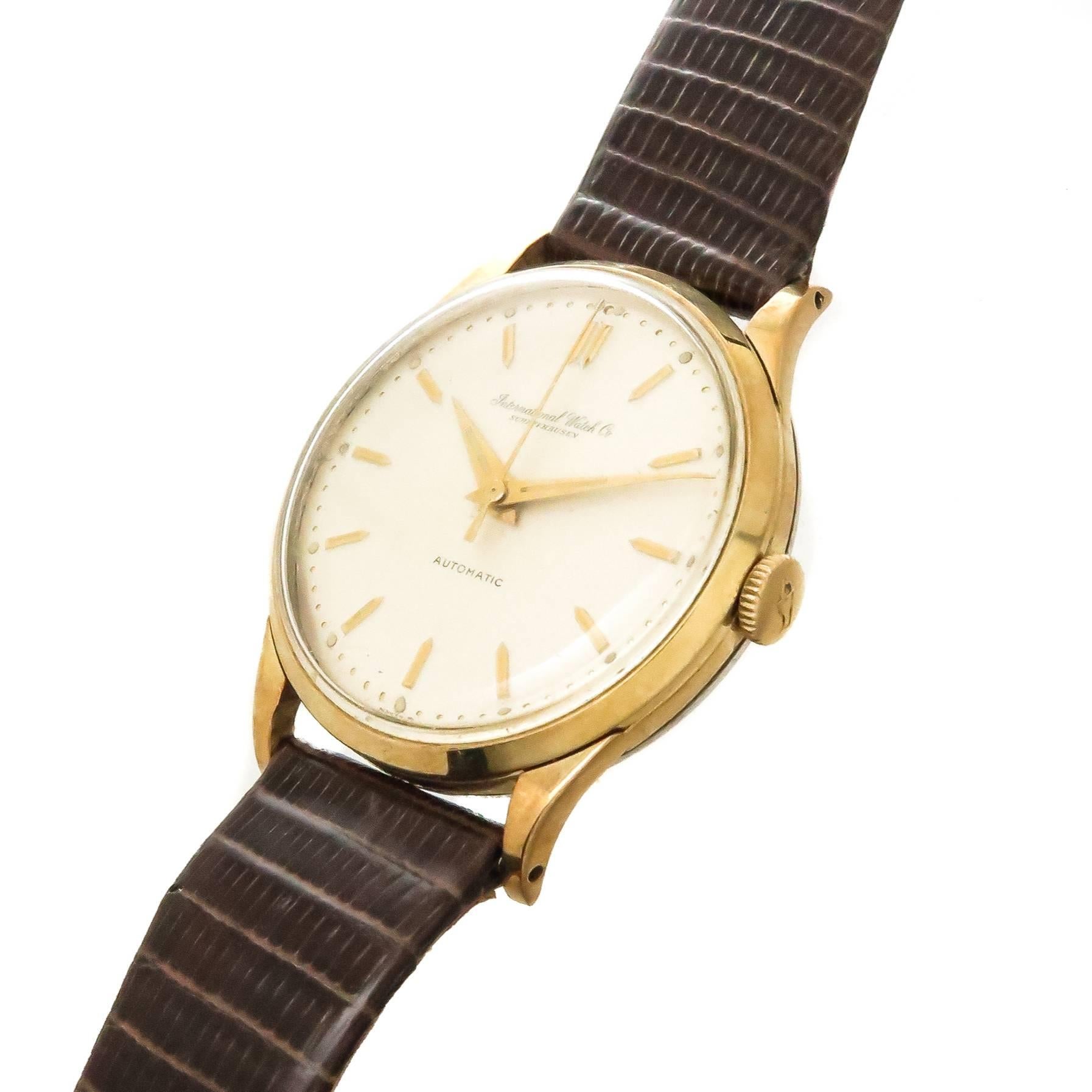 Circa 1960 I W C, International Watch Company Schaffhausen Gents Wrist Watch, 34 MM Gold Plate case with Stainless Steel Back.  21 Jewel automatic, self winding movement. Original, Mint condition White dial with Raised Gold Markers and a sweep