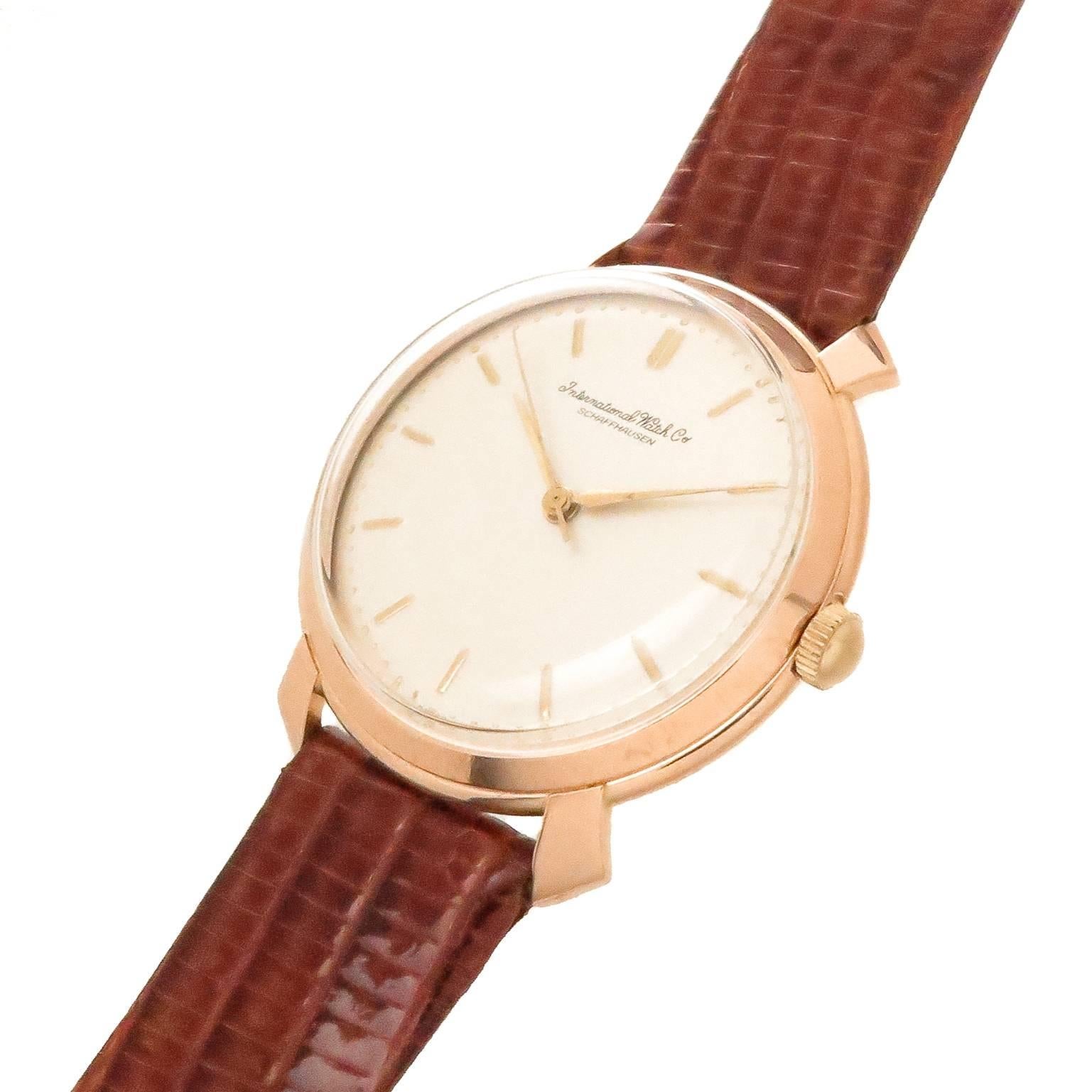 Circa 1940s International Watch Company IWC Schaffhausen Wrist Watch.  37 MM 18K Rose Gold 3 Piece case with Flared Lugs. Caliber C.89  17 Jewel Manual Wind Nickel Lever movement.  Silvered Dial with raised Gold markers, Gold Hands and a Sweep