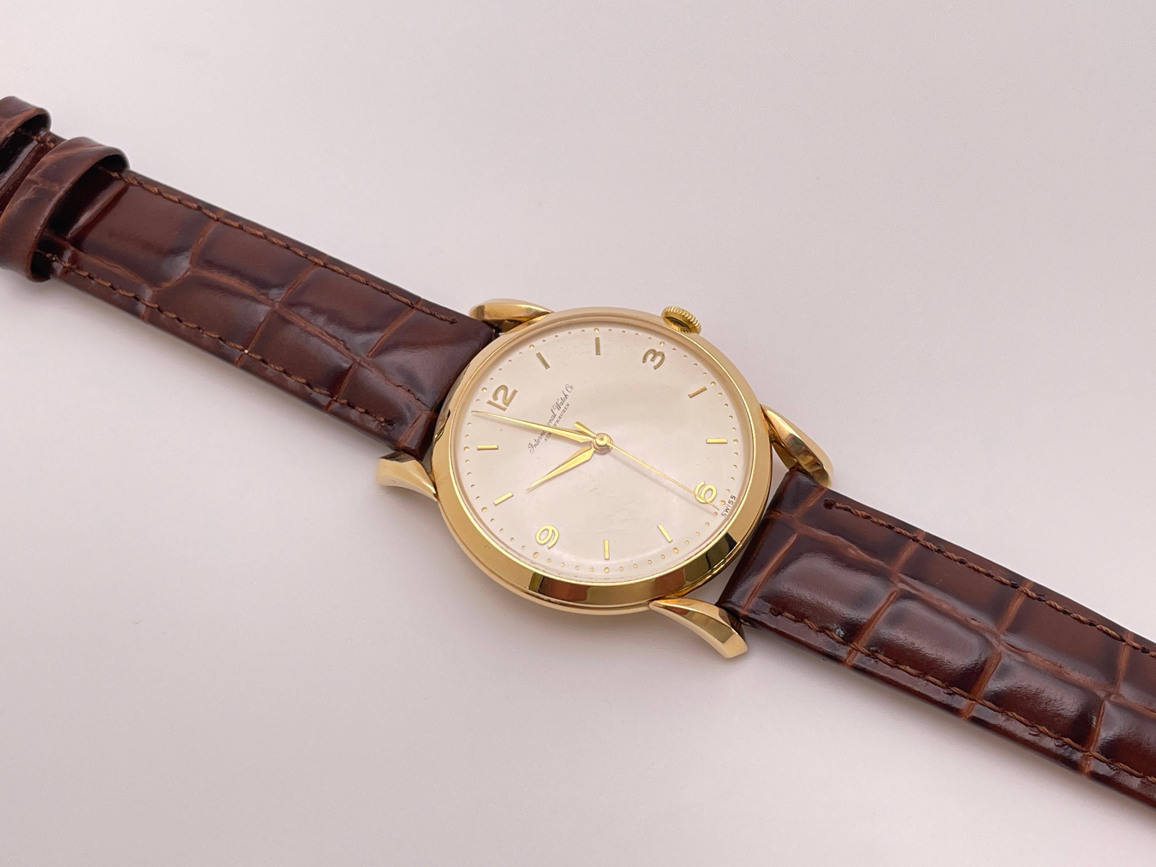An authentic 18K yellow gold IWC (International Watch Company) Schaffhausen watch, circa 1960s. 

This beautiful watch features an 18K marked yellow gold case, mechanical movement, champagne dial, gold tic marks/numbers, and gold hands (S, M, H).