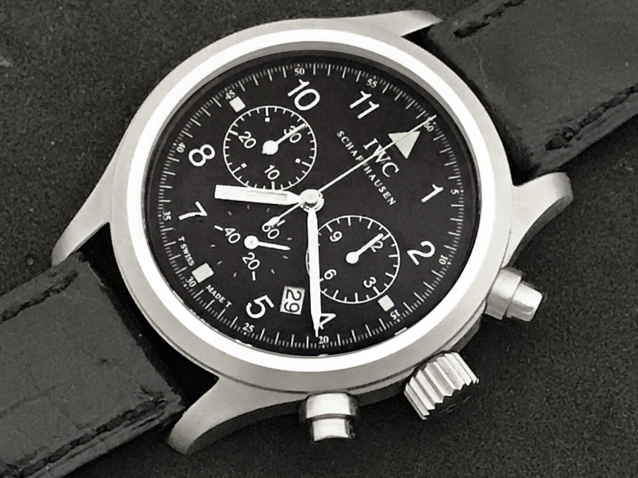 The IWC Der Flieger Classic Pilot Chronograph, certified pre-owned contemporary men's quartz with date wrist watch.  Rich black dial with white luminous arabic numbers. Stainless Steel round waterproof style case (36mm dia.) Black alligator strap