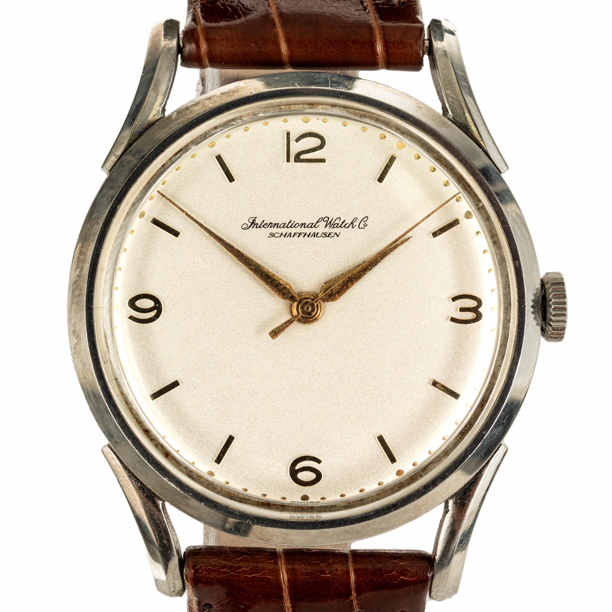 Step back in time with the IWC stainless steel Men's wristwatch from the late 1940s. White pristine dial with gilt hands and markers  and new leather band and buckle. The case is 45mm long with diameter of 36mm. A masterpiece that transcends eras