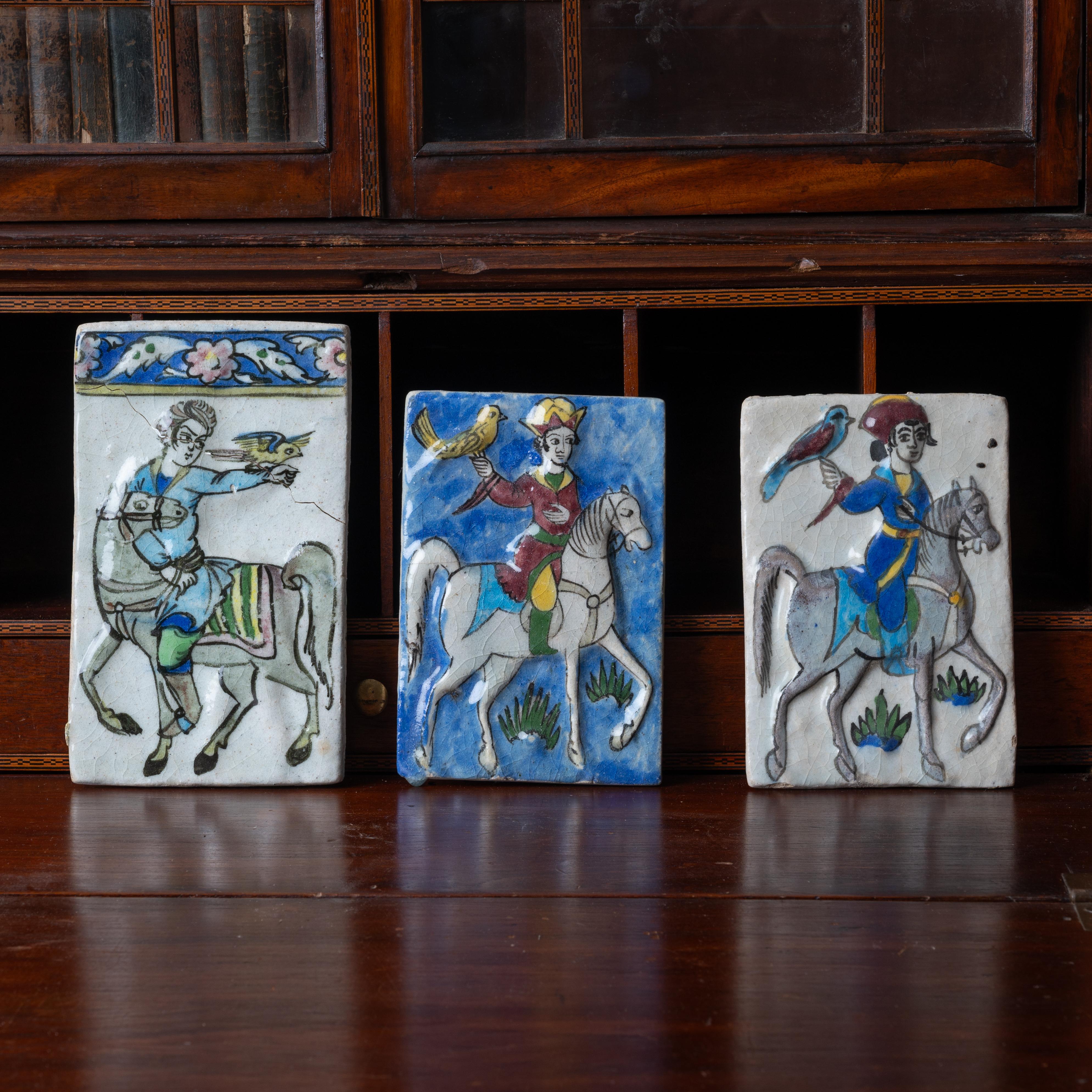 A set of three Iznik Qajar style ceramic tiles.

largest: 5 ½ by 9 ½ inches
smaller: 8 inches tall

