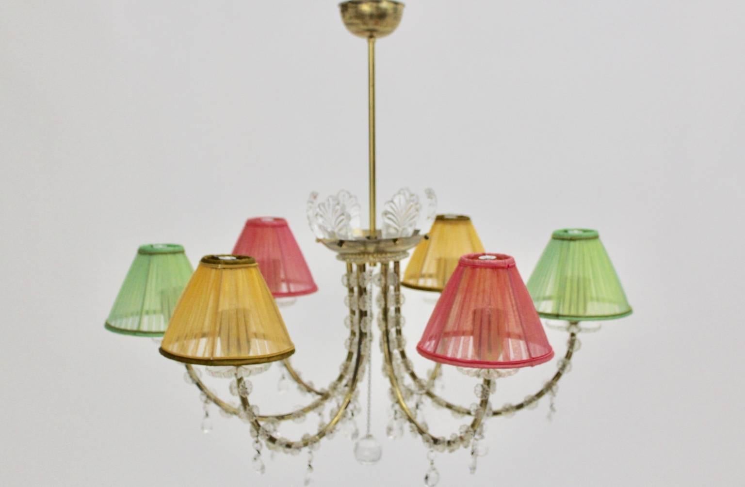 Mid Century Modern vintage brass crystal chandelier by J. & L. Lobmeyr, which is decorated with beautiful glass flowers and crystal elements.
This high-quality chandelier was designed and executed by J. & L. Lobmeyr Vienna Austria.

The chandelier
