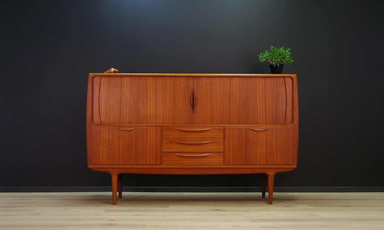 Phenomenal highboard from the 1960s-1970s, Danish design, Minimalist form designed by J.Andersen. Furniture covered with teak veneer. Roomy interior with shelves behind the sliding doors. In addition, three drawers and two barges. Preserved in good