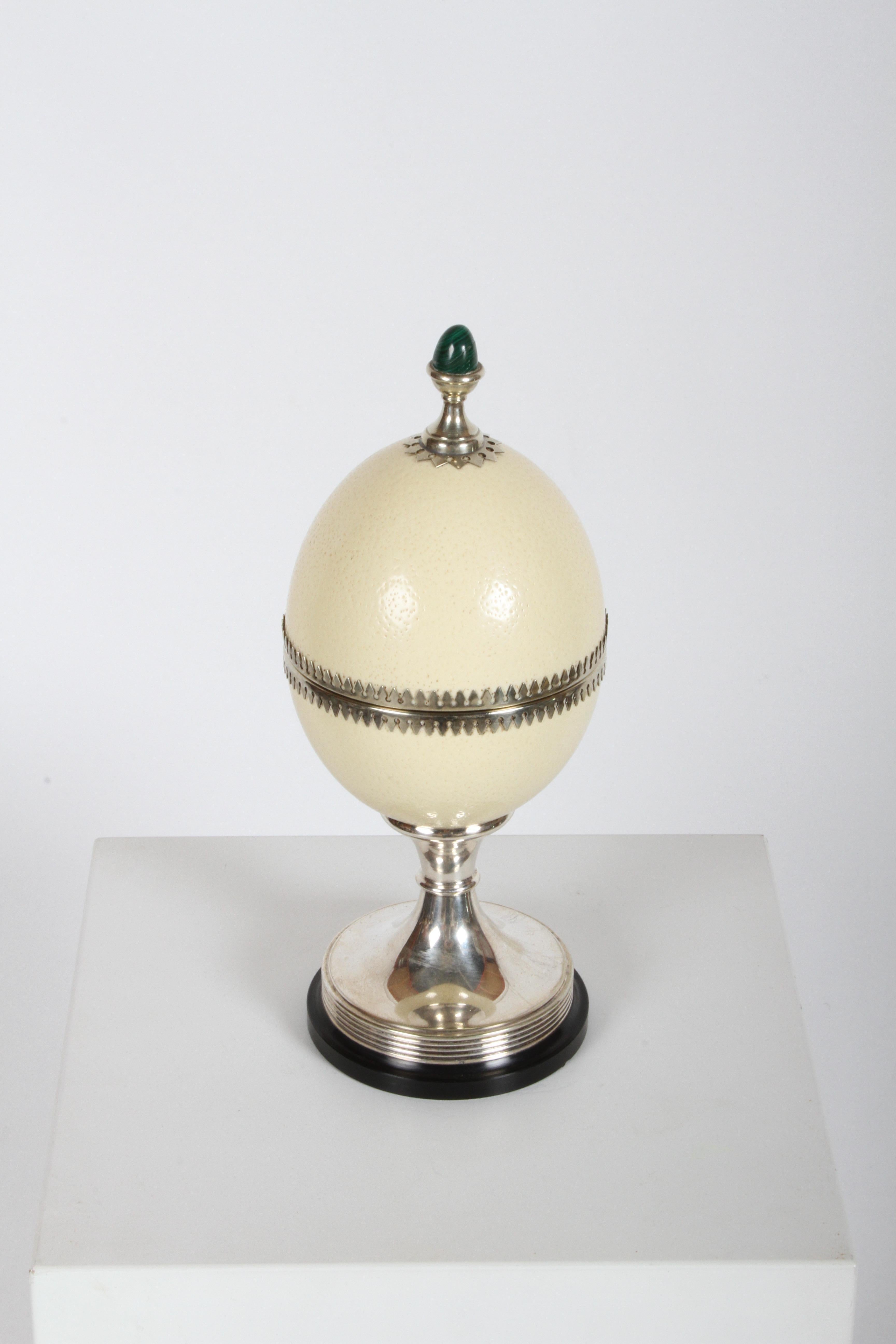 Unique footed ostrich egg box by J. Antony Redmile, accented with silver plate trim work, topped with an egg-shaped malachite finial and set atop a black lacquered wood base. Unsigned, but no doubt by Redmile. Often misspelled as Anthony Redmile,