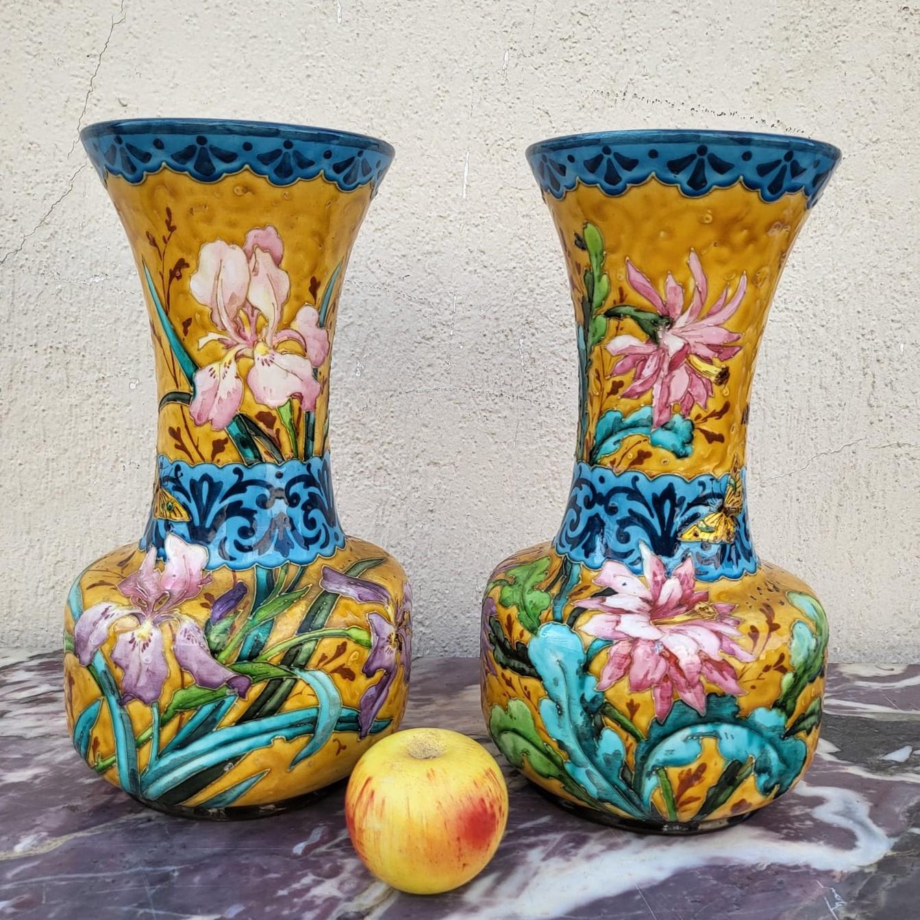 Pair of vases in the style of Théodore Deck, in polychrome and gold enamelled ceramic: Japanese decor of flowers (iris, dahlias and cherry blossoms) and animals (butterflies) on a yellow background
Blue enamelled interior

Wear from use and