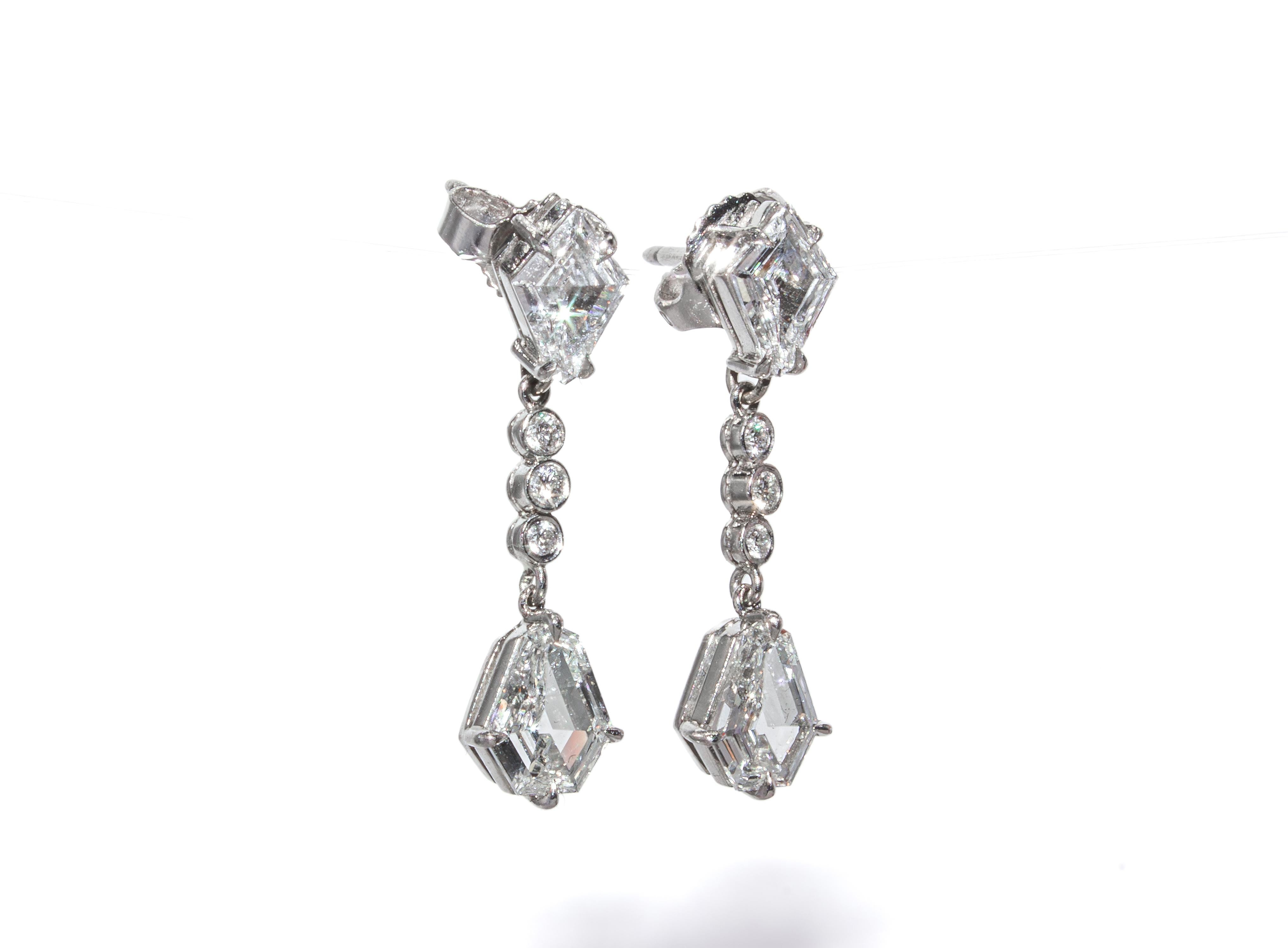 These exquisite J. Birnbach drop earrings are a striking display of precision-cut diamonds and exceptional craftsmanship. Crafted in platinum, the earrings feature two stunning kite-cut diamonds totaling 1.05 carats, each graded F color and VS1