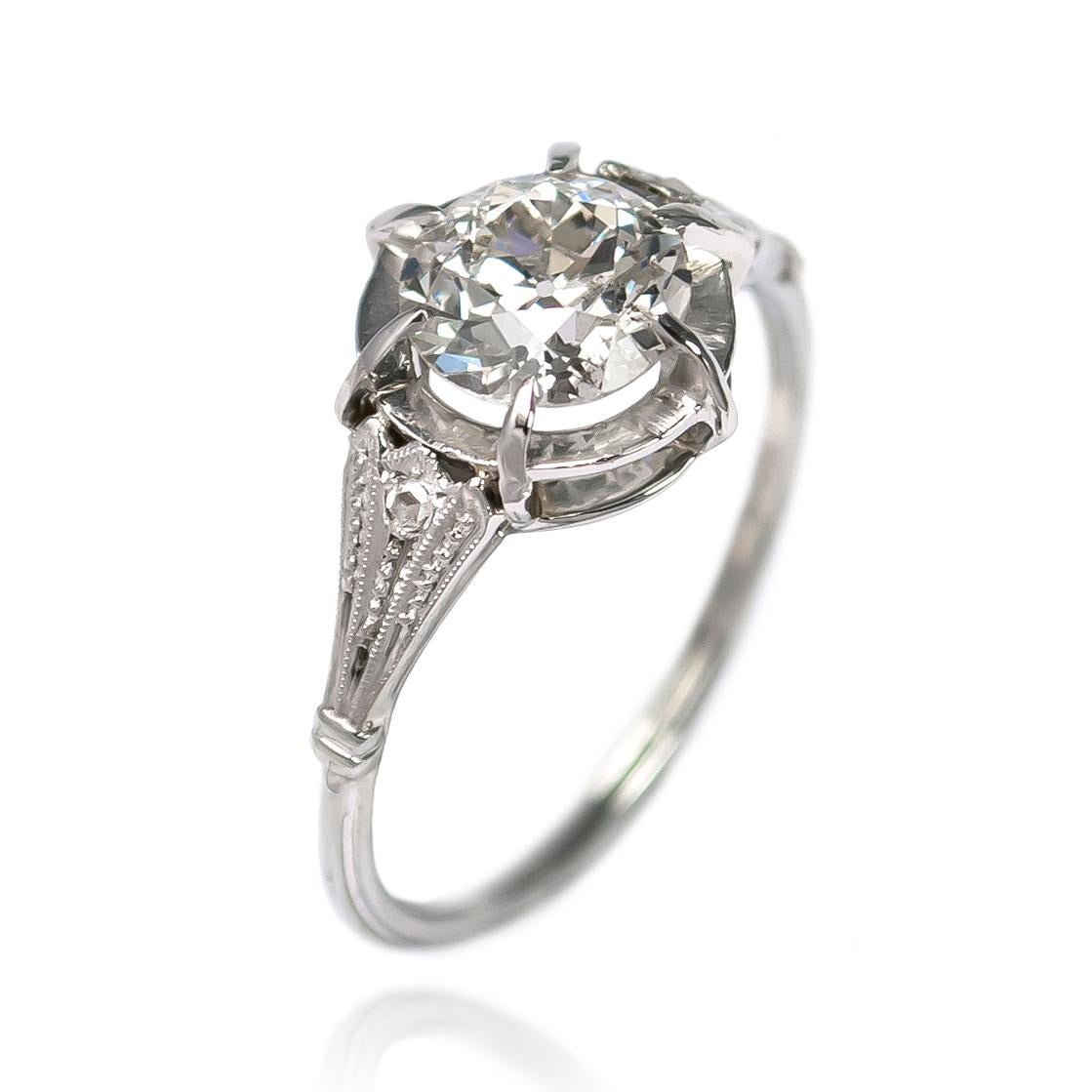 This sweet ring is a special piece from the J. Birnbach vault! This unique antique engagement ring features a 1.19 carat Old Euro round diamond, I color and I1 clarity. The handmade platinum setting is full of intricate detail, perfect for someone