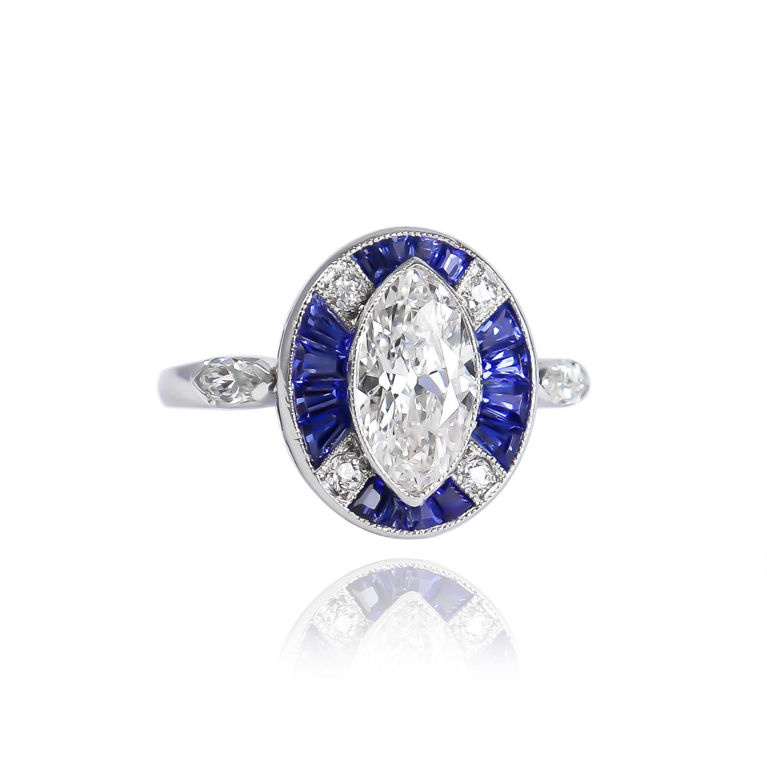 This exquisite piece new to the J. Birnbach vault features a 1.20 carat modified marquise brilliant cut diamond of E color and SI1 clarity. Set in its original, handmade, platinum ring mounting with a sapphire and diamond halo, this piece is a