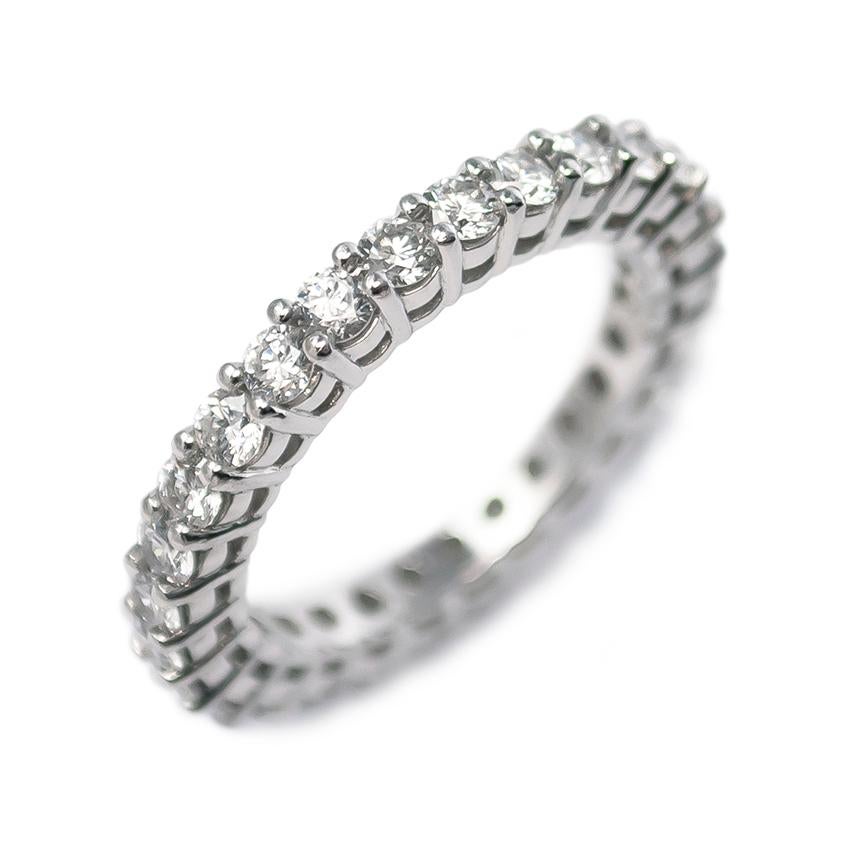 This beautiful, scintillating eternity band is set with 28 Brilliant Round diamonds of F color and VS+ clarity = 1.40 carat total weight. Handmade in platinum with shared prongs and an airline detail, this is the perfect accompaniment to any