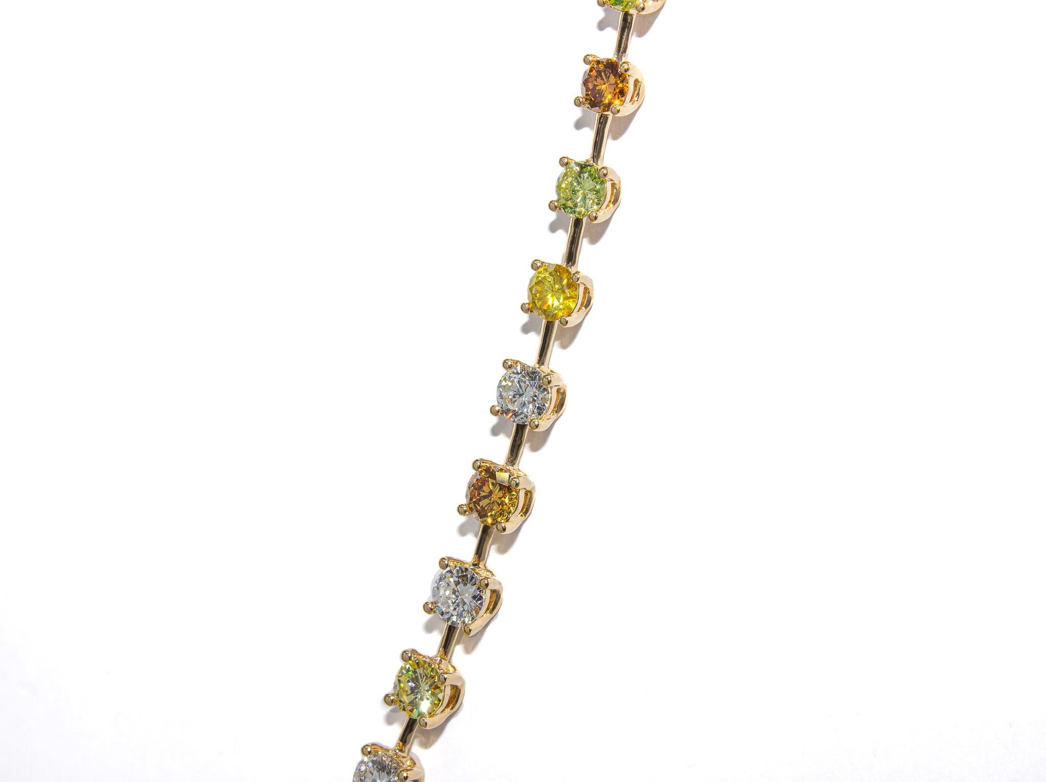This extraordinary 18K yellow gold tennis necklace is a celebration of color, craftsmanship, and rarity. Featuring 14.26 carats of assorted fancy color round brilliant diamonds—including shades of yellow, green, orange, brown, and pink—each stone is