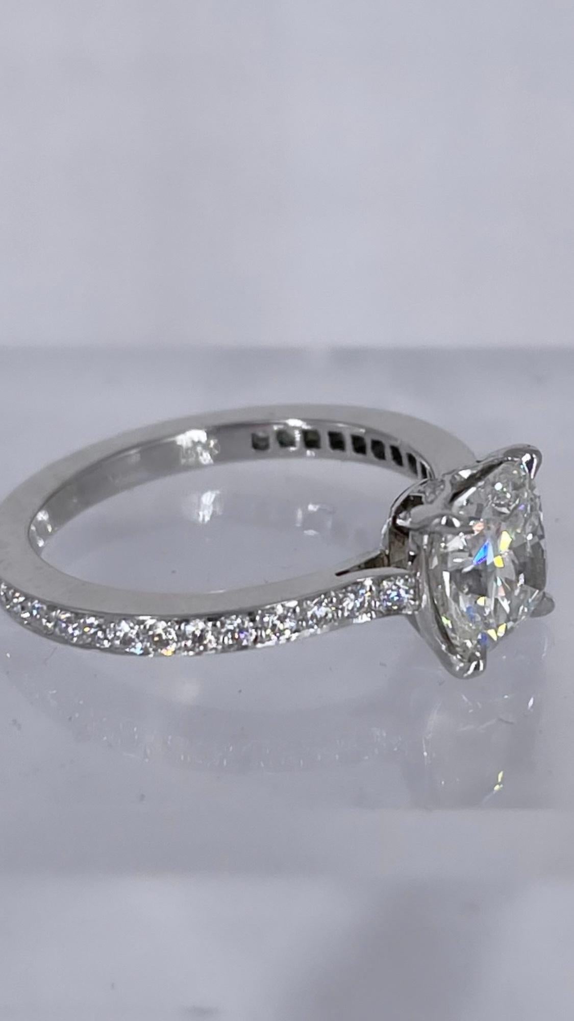 This sparkling engagement ring by J. Birnbach features a gorgeous 1.50 carat cushion cut diamond. It is GIA certified G color and SI1 clarity. This diamond has a beautiful square shape, with the signature brilliance and soft rounded corners of a