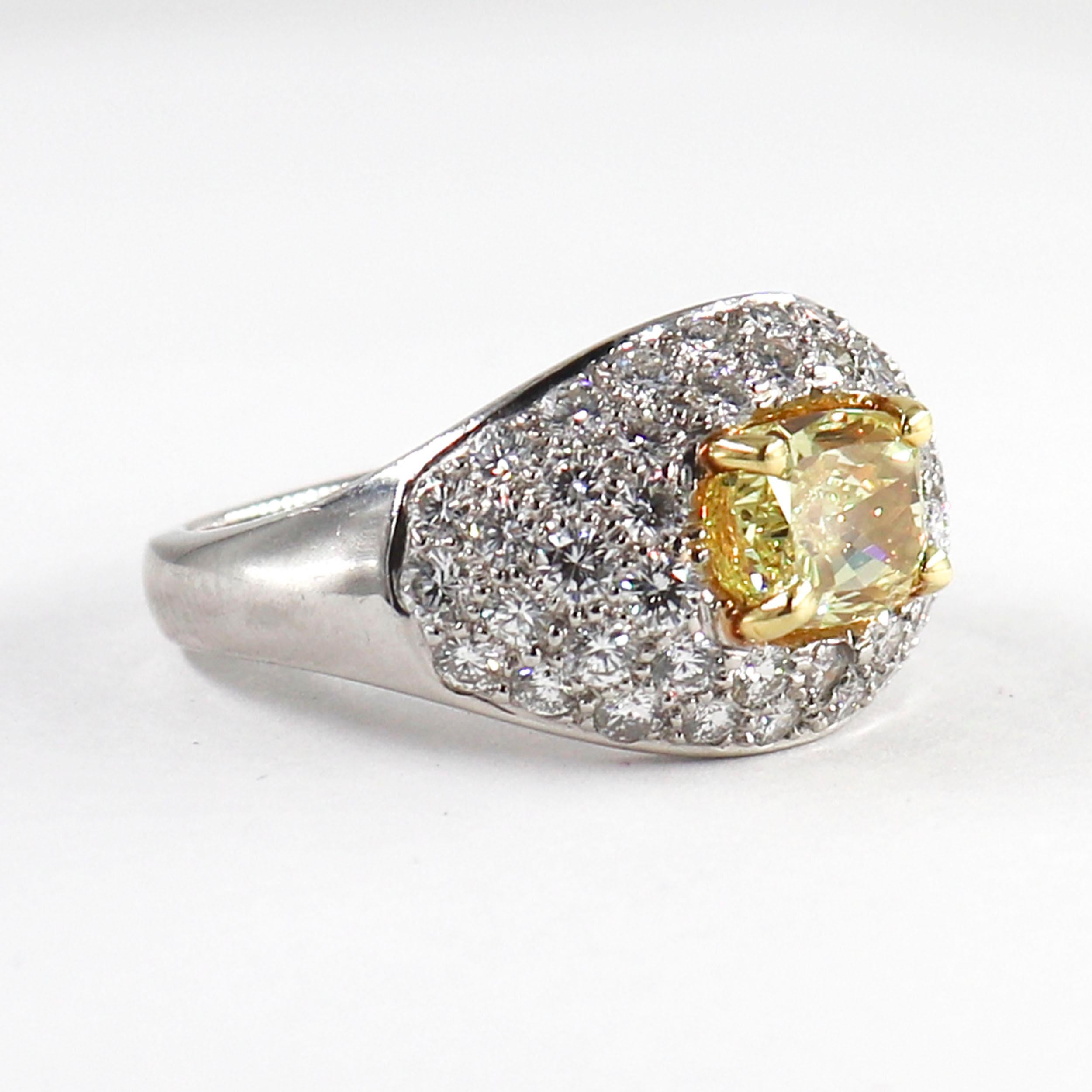 The ultimate statement piece! This bright and bold ring is perfect for anyone who loves color and sparkle. The ring features a 1.53 carat cushion yellow diamond, graded by GIA to have a fancy intense color grade. This rich, saturated color is a