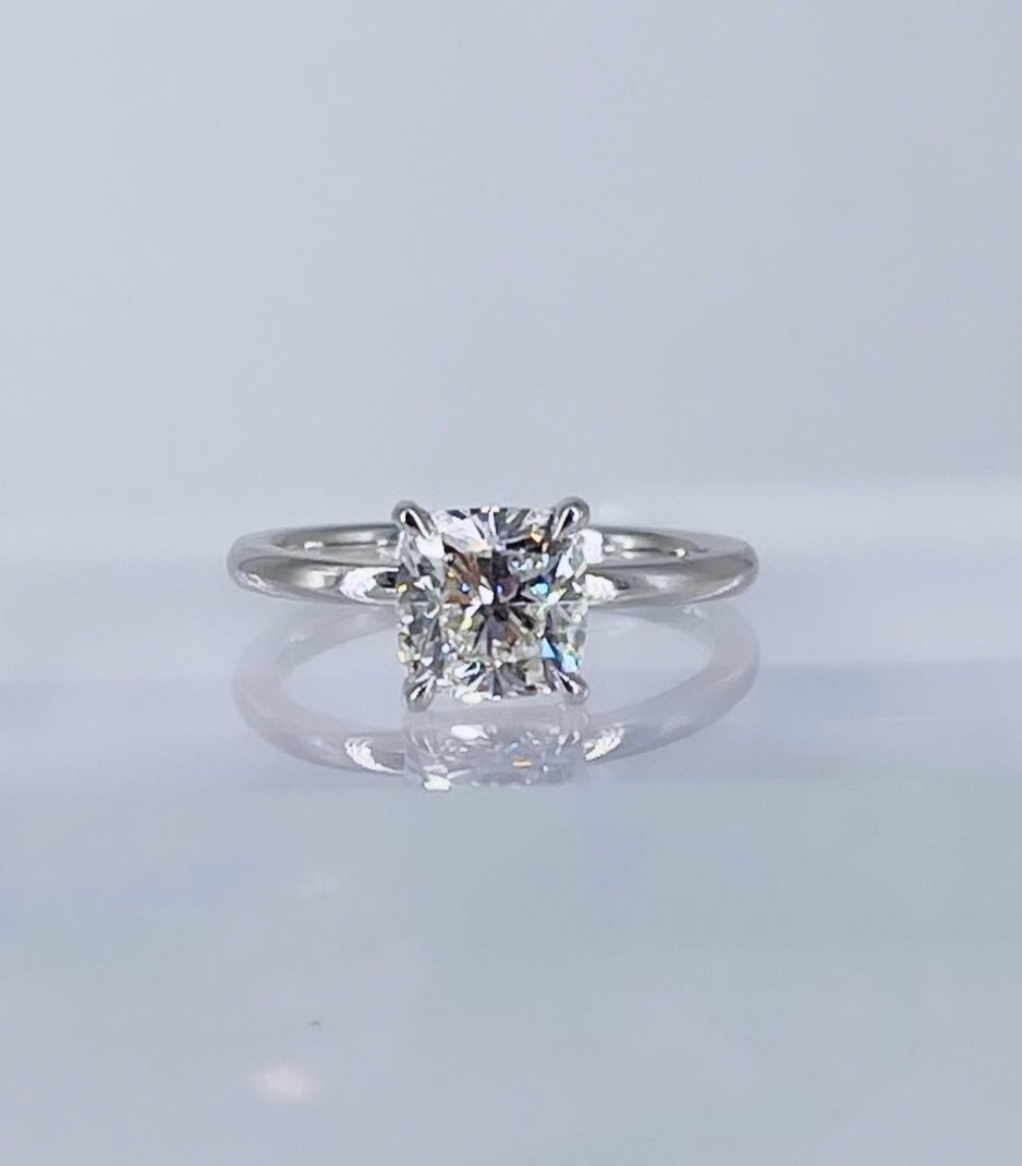 The epitome of modern elegance, this sleek solitaire by J. Birnbach features a 1.60 carat GIA certified cushion cut diamond with H color and SI1 clarity. Lively and sparkly with a slightly elongated shape, this diamond will light up any room! The