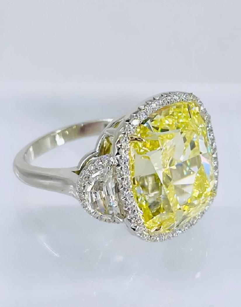 This glamorous, sunshine yellow ring is a showstopper! The ring features a gorgeous 16.06 carat cushion cut diamond, certified by GIA as Fancy Yellow color and VS2 clarity. The center diamond is slightly elongated, and the beautiful shape is