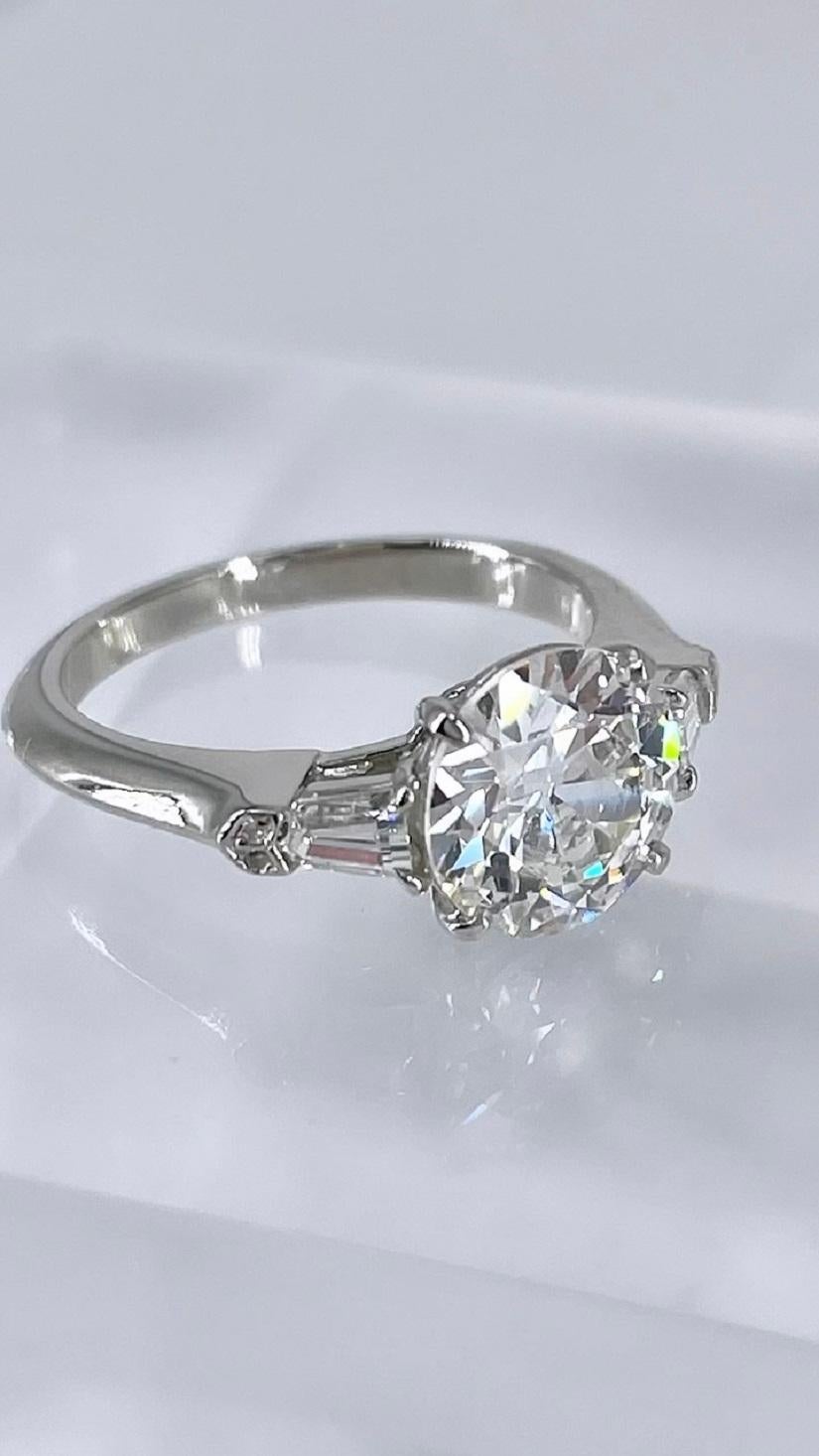 This stunning engagement ring by J. Birnbach features a 1.97 carat European cut diamond, certified by GIA as G color and SI1 clarity. This charming diamond has the delightful sparkle, larger facets, and visible culet that are characteristic of