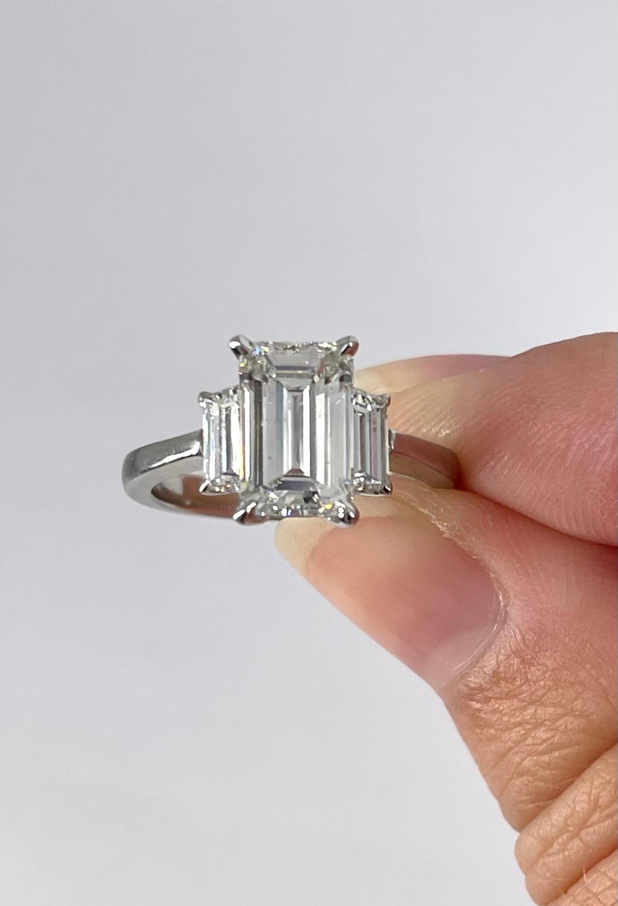 emerald three stone engagement ring