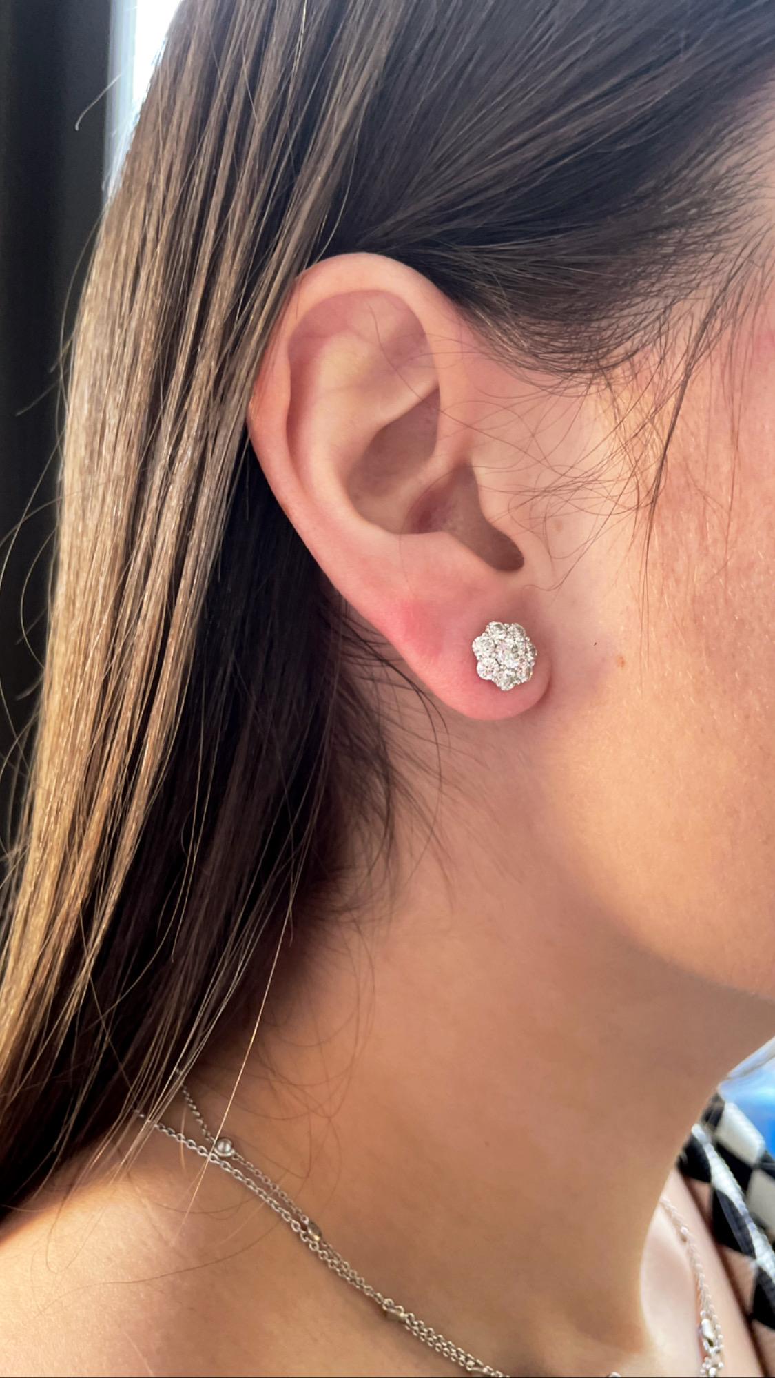 These sweet earrings by J. Birnbach are a beautiful staple jewelry piece. Crafted in 18 karat white gold, H color and VS clarity round diamonds sparkle in a classic floral shape. The diamonds total 2.10 carats. This size and style is wearable for