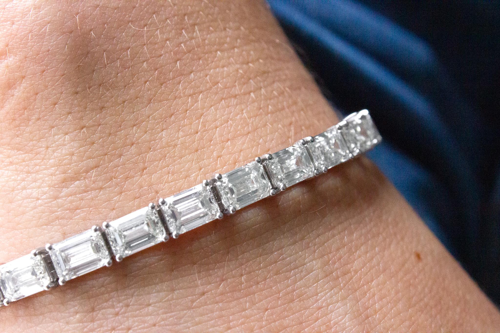 Elevate your jewelry collection with this exquisite 18K White Gold East/West Prong Set Diamond Bracelet. This stunning bracelet features 21 GIA certified emerald-cut diamonds, totaling an impressive 21.14 carats, each showcasing I - J color and IF -