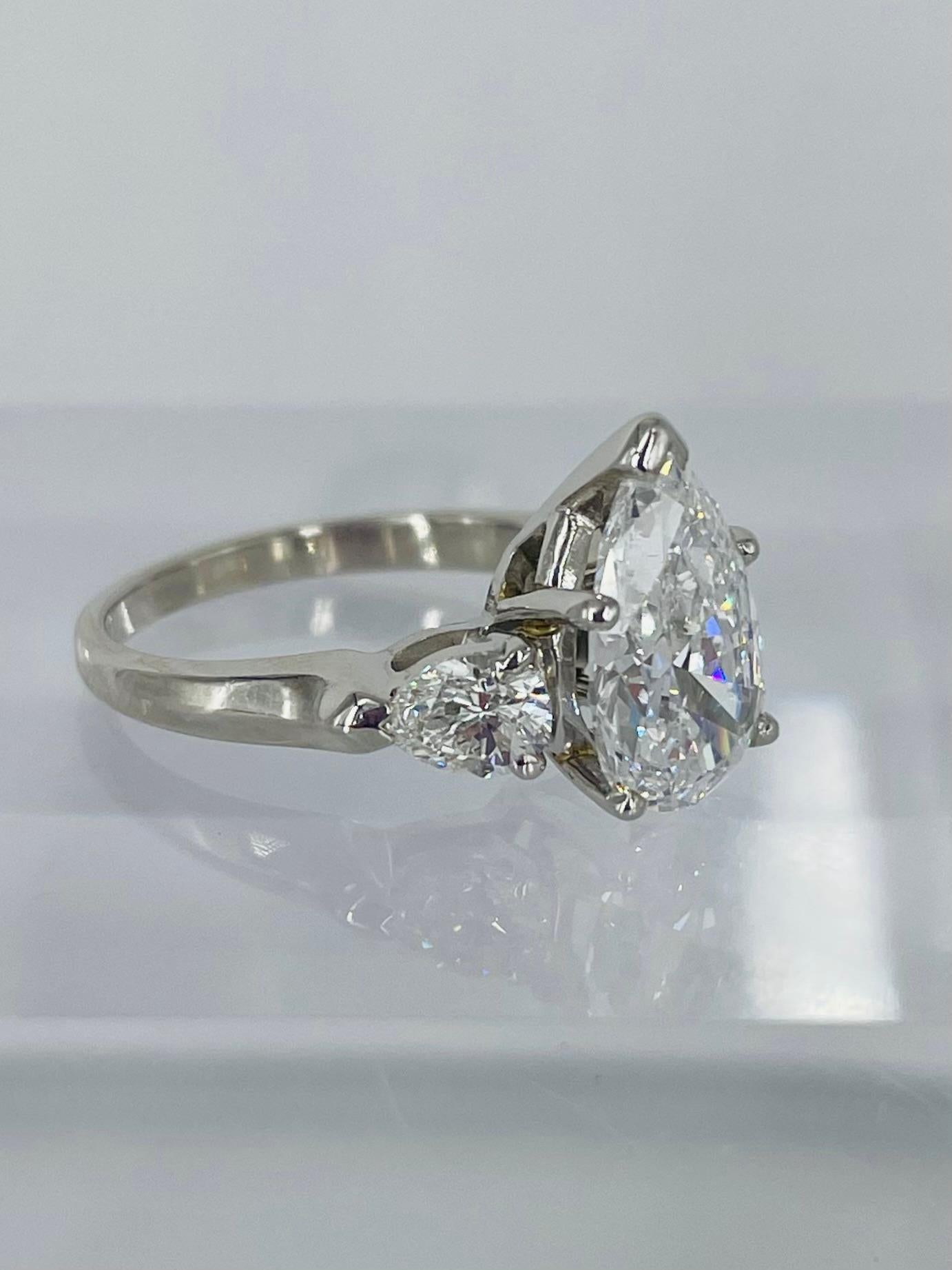 This sweet, sparkling ring by J. Birnbach features a beautifully matched trio of pear shaped diamonds. The center diamond is a GIA certified 2.18 carat pear shape with D color and SI2 clarity. D is the highest possible color grade, which makes this