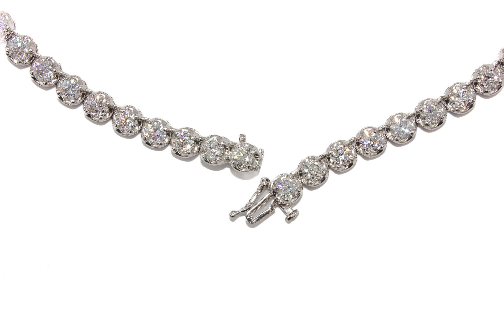 This breathtaking platinum diamond tennis necklace is a true statement of elegance and brilliance. Expertly crafted, it features a stunning array of 70 round brilliant diamonds, totaling an impressive 28.46 carats. Each diamond is meticulously