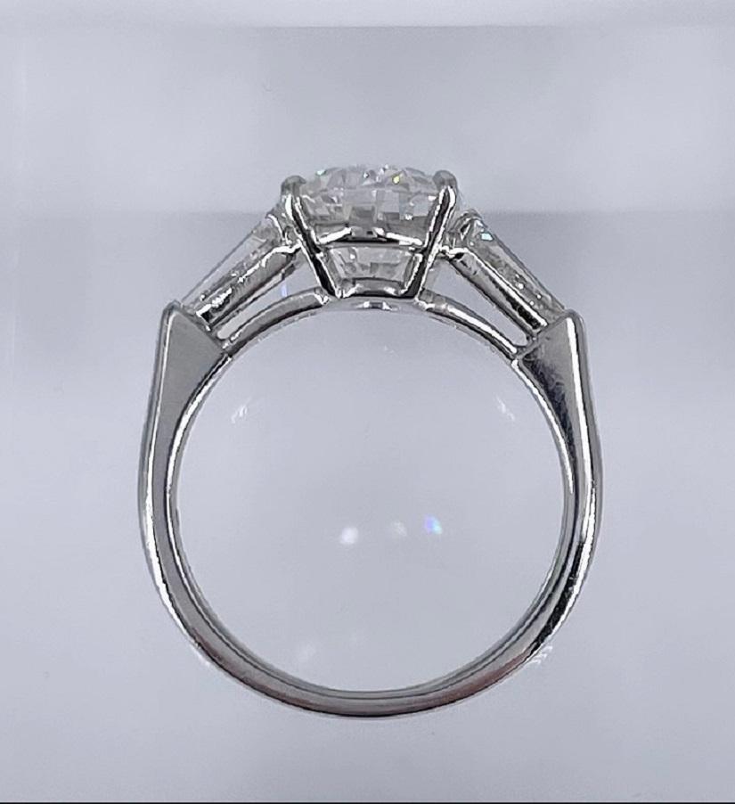 This engagement ring is a timeless classic! The ring features a 3.02 carat oval diamond certified by GIA as G color and SI2 clarity. The tapered baguettes (0.55 carats total) draw the eye to the center diamond and add a touch of sparkle to the