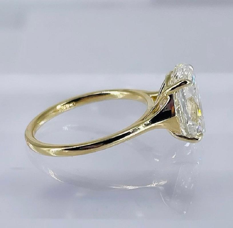 This sparkling modern solitaire engagement ring by J. Birnbach features a gorgeous GIA certified 3.95 carat oval diamond. The diamond is I color and SI2 clarity, GIA report number 6224603133. The ring is crafted in 14K yellow gold, and is finger