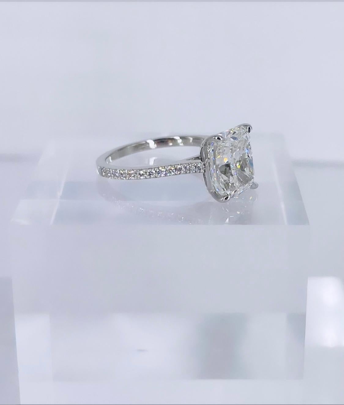 This feminine  engagement ring features one of our most popular shapes, an exceptionally elongated cushion. The diamond is certified by GIA to be I color and VS2 clarity. It is white, bright, and extremely lively and brilliant. It is difficult to