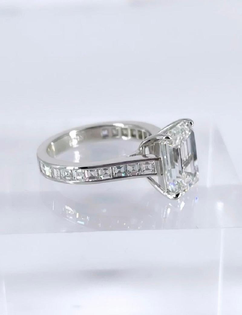 This elegant engagement ring by J. Birnbach features a 4.03 carat emerald cut diamond, certified by GIA as G color and VS1 clarity. The setting is simple and sophisticated, with 1.08 carats carre cut diamonds. Carre cut diamonds are a square step