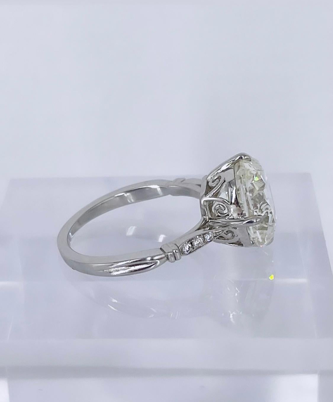 Perfect for the romantic in your life, this gorgeous engagement ring by J. Birnbach features a rare 5.01 carat antique cushion brilliant diamond. The larger faceting and distinct cutting style give this diamond a beautiful lively sparkle. It is