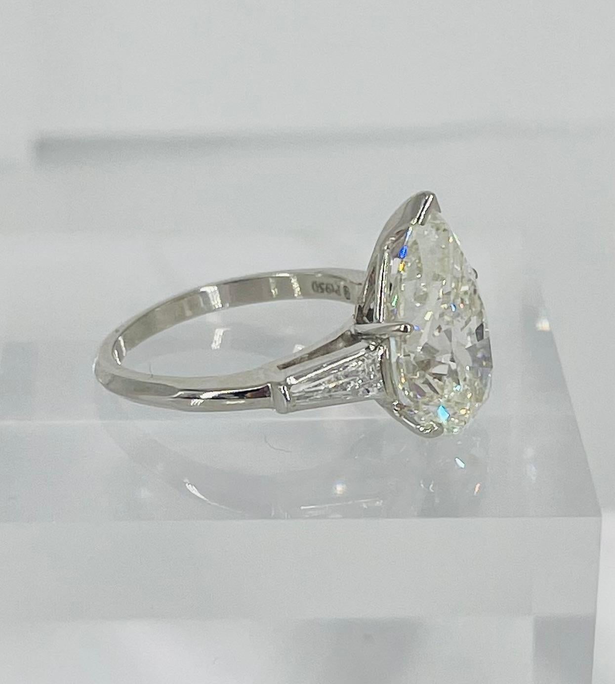 This classic three stone engagement ring by J. Birnbach features a stunning 5.52 GIA certified pear shape diamond. The diamond is K color and SI2 clarity, and has a beautifully elongated shape that is very flattering on the finger. The setting is