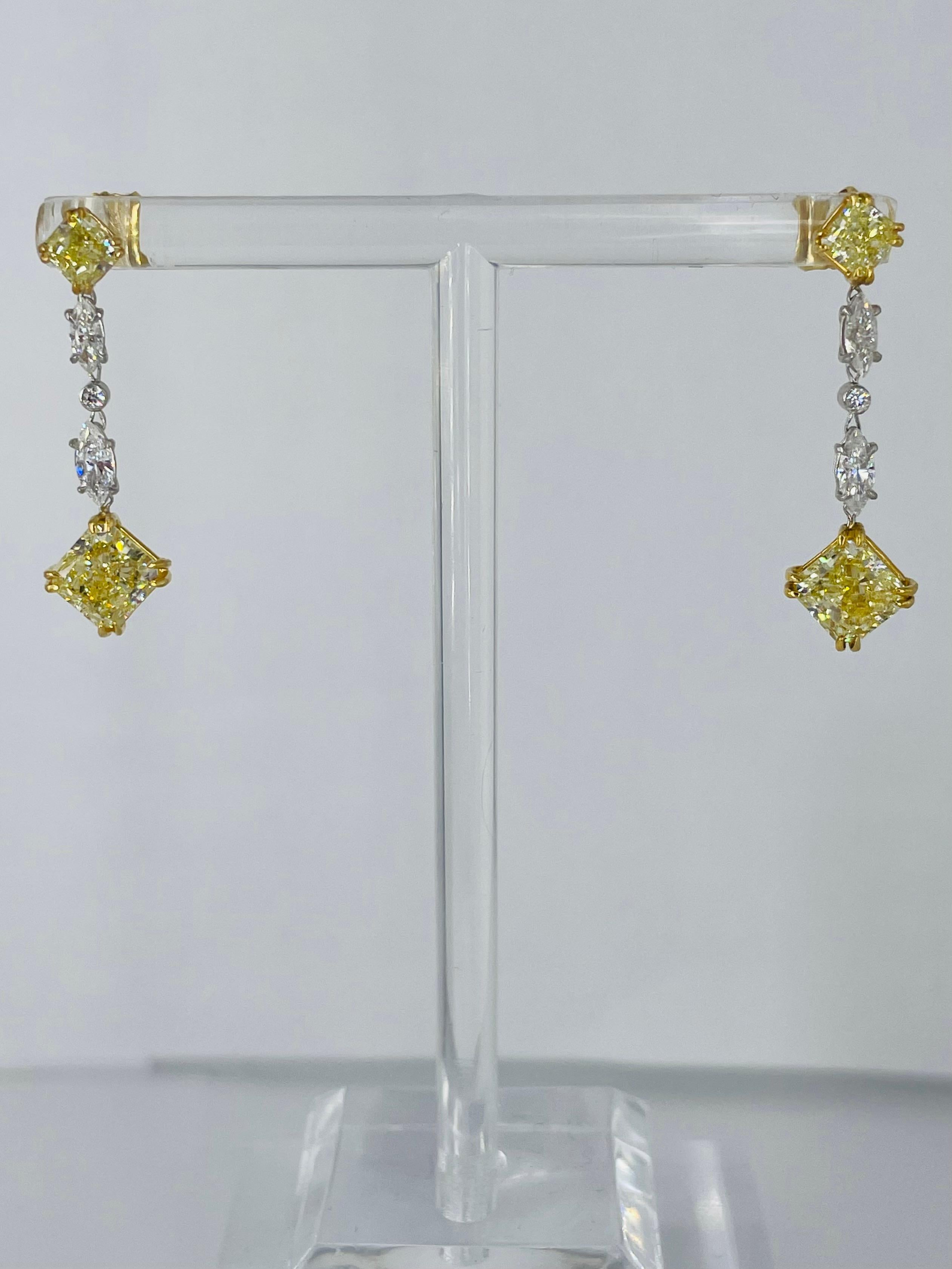 These sparkling, playful earrings by J. Birnbach are the perfect addition to any jewelry collection! Crafted in 18K yellow gold and platinum, the earrings begin with a fancy yellow radiant stud, followed by white marquise and round diamonds, and are