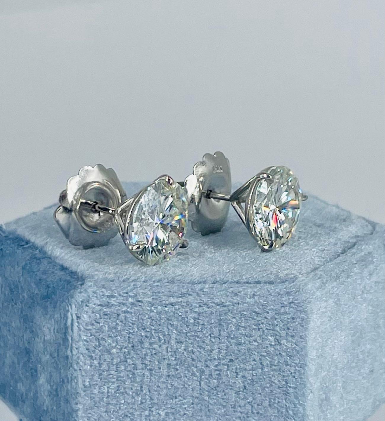 Stunning for every day wear or a special occasion, these studs are a showstopper! This beautifully matched pair of sparkling round diamonds is certified by GIA as I color and SI2 clarity, one weighing 3.13 carats and the other 3.05 carats, for a