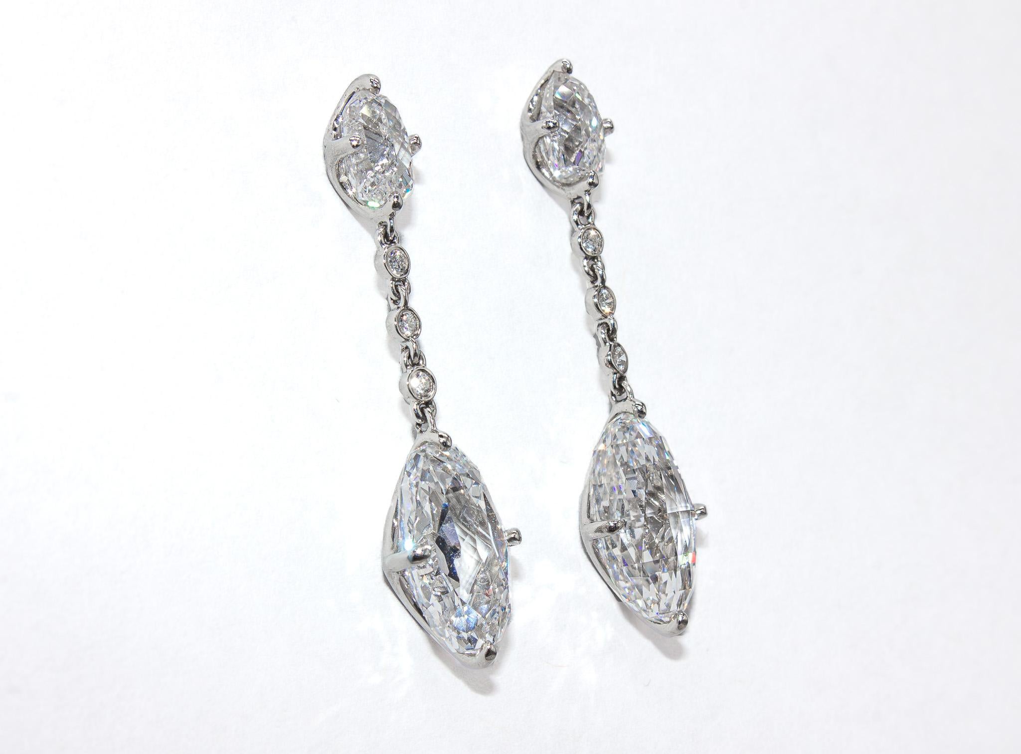 These exceptional one-of-a-kind earrings by J. Birnbach are a dazzling addition to any fine jewelry collection. Showcasing two rare and extraordinary briolette-cut diamonds, these earrings exude elegance and timeless beauty. The dangling diamonds,