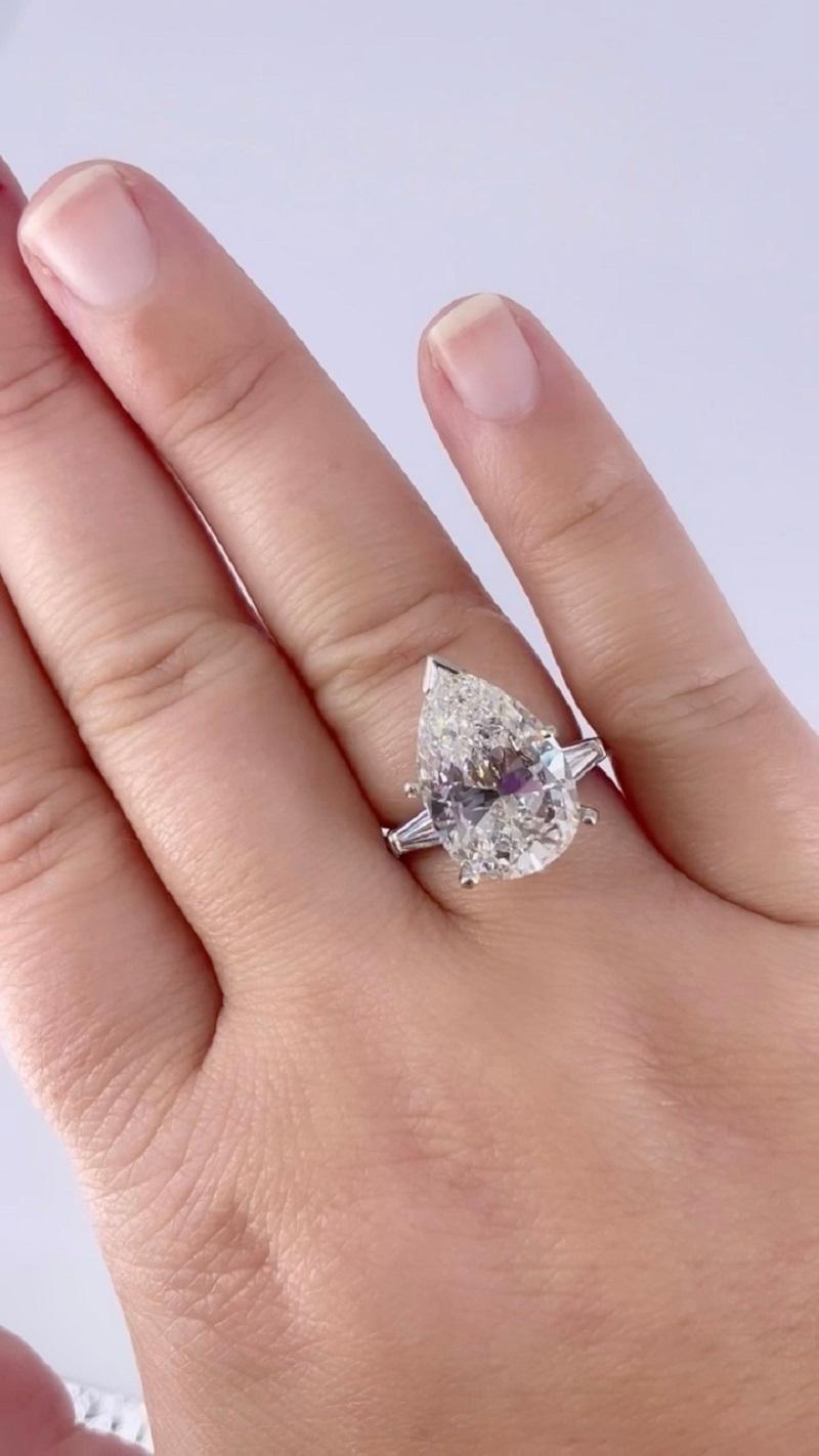This timeless engagement ring by J. Birnbach features a stunning 6.37 carat pear shape diamond, certified by GIA as I color and SI2 clarity. This lovely diamond is a beautiful shape, full and impactful and gently tapering to the point. The center