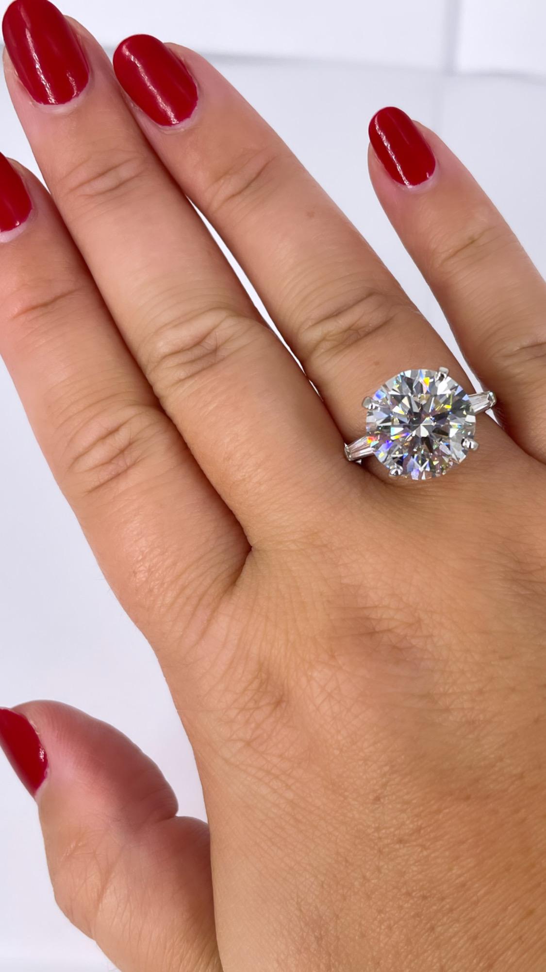 A stunning take on a classic design, this 7.33 carat round diamond with petite tapered baguettes by J. Birnbach is a modern version of a timeless style. The delicate tapered baguettes are a subtle accent of sparkle and allow the center diamond to be