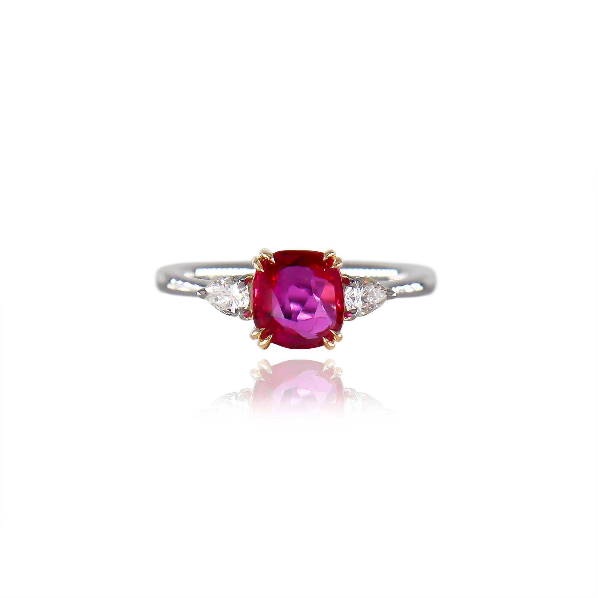 This incredible, fresh execution from the J. Birnbach workshop features an AGS certified 1.29 carat pinkish-red ruby of Burmese origin with NO heat treatment. Set in a platinum and 18K yellow gold, three-stone ring with pear brilliant cut diamonds