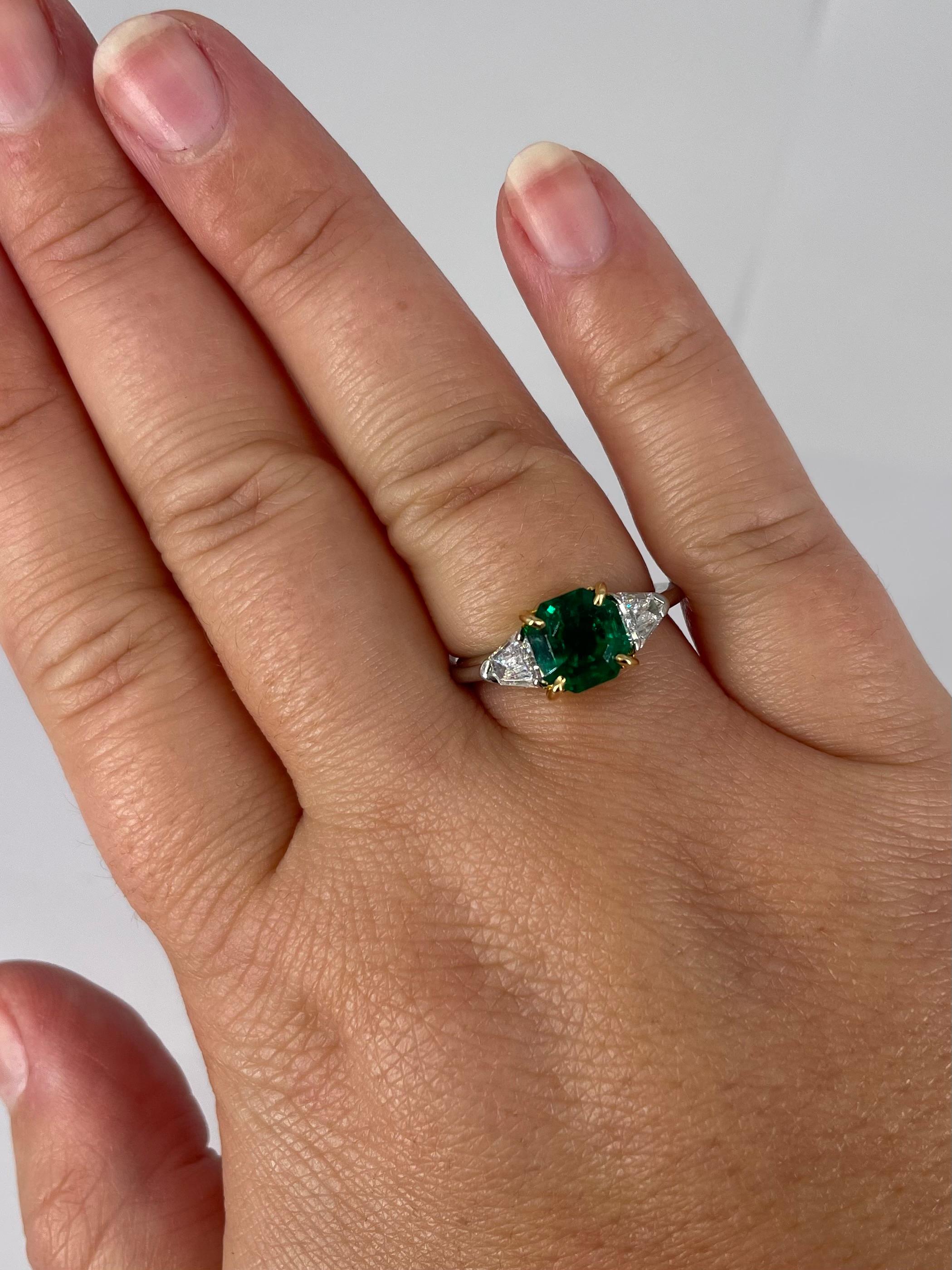 emerald and diamond three stone ring