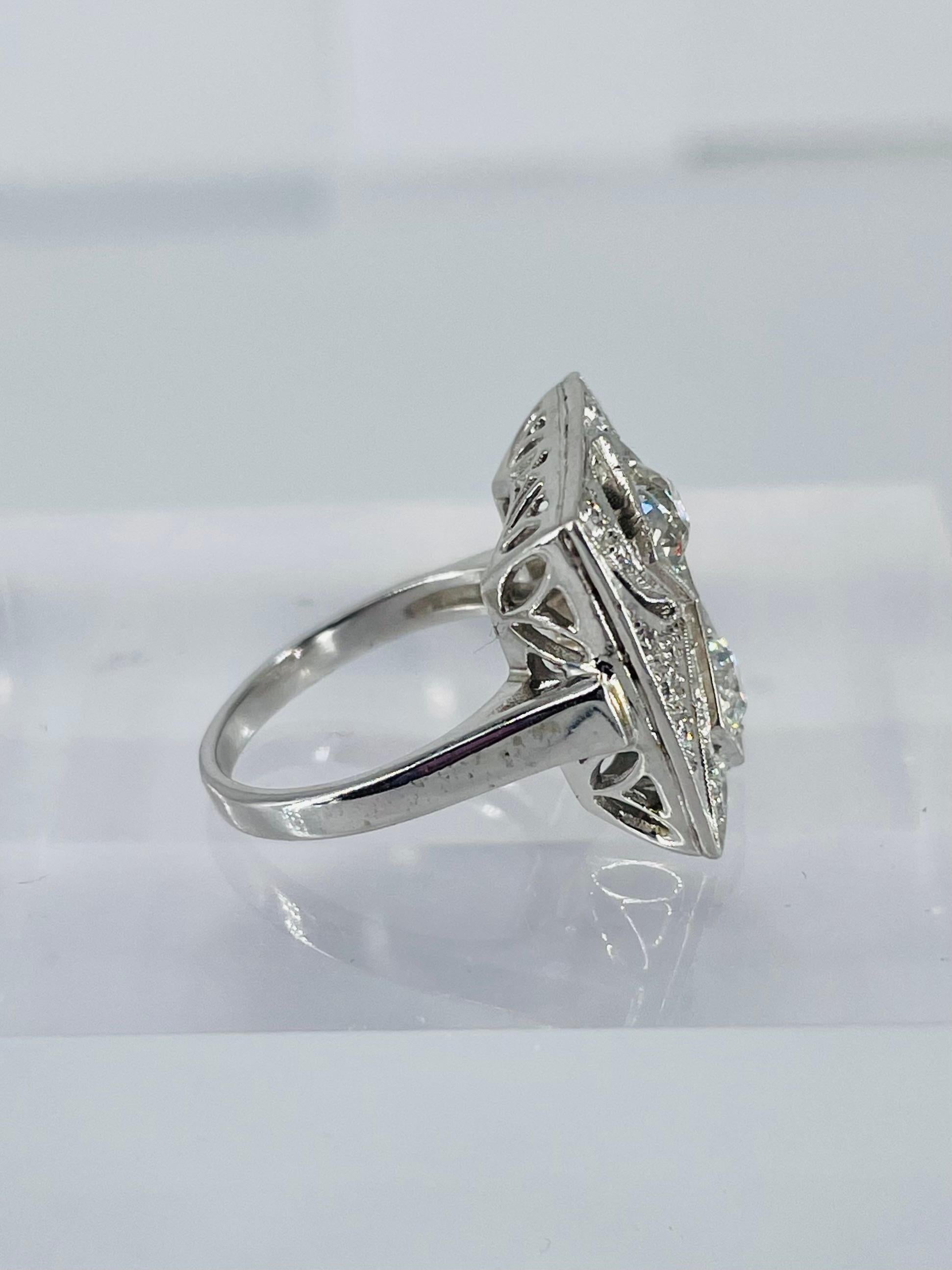 This exquisite antique from the J. Birnbach vault is a one of a kind statement piece. The ring showcases two European cut diamonds, total 1.00 carat, which were cut in the early 1900s. 
The setting was crafted in the 1950s. It is 14K white gold with