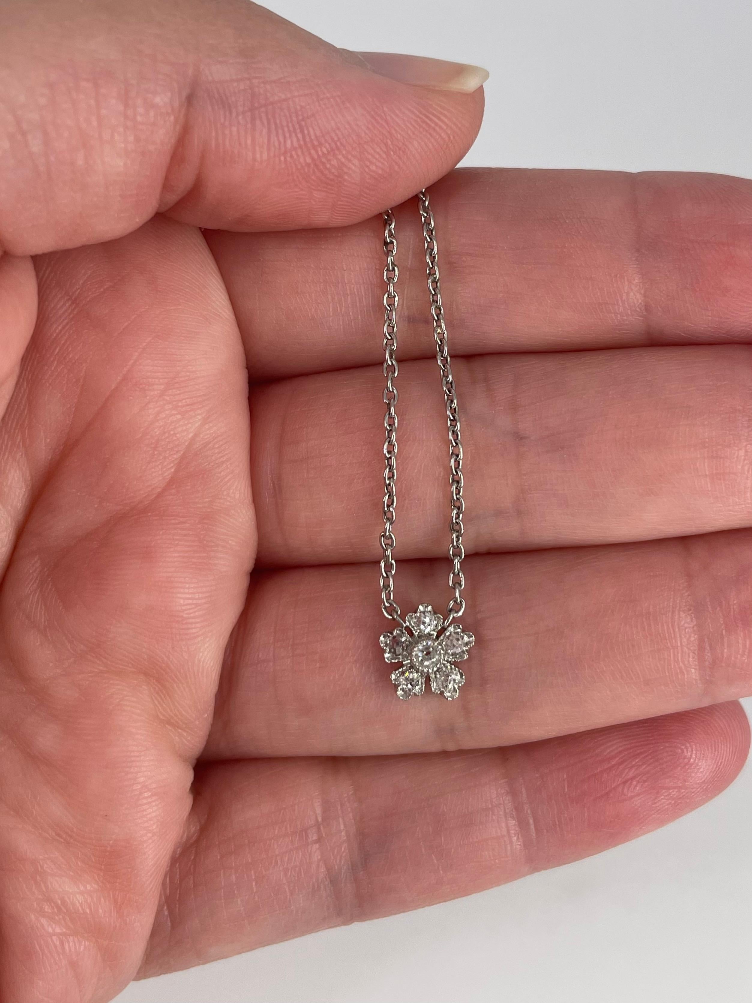 This sweet antique pendant necklace is the perfect accent to any look! J. Birnbach repurposed an antique pin, using the flower design to create this pendant. The flower features antique cut round diamonds and delicate millgrain detail. The chain is