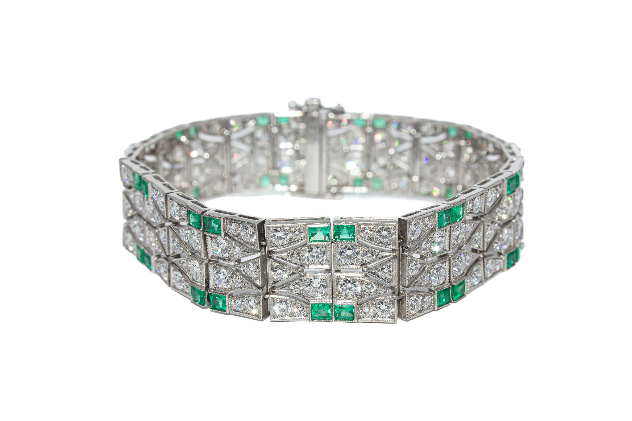 A masterpiece of the Art Deco era, this platinum bracelet is a striking display of bold geometry and refined elegance. Set with approximately 11.00 carats of sparkling diamonds and 4.50 carats of richly hued emeralds, the design captures the glamour