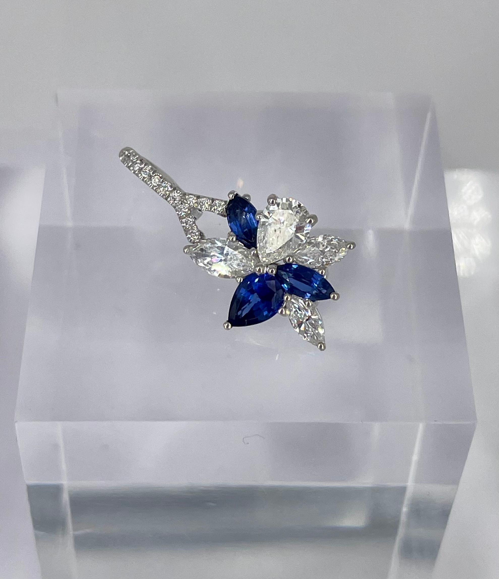 These elegant earrings by J. Birnbach are a beautiful way to incorporate blue sapphires into your jewelry collection. Crafted in 18K white gold, these  lever back earrings showcase a beautifully balanced floral design. The cluster of diamonds and