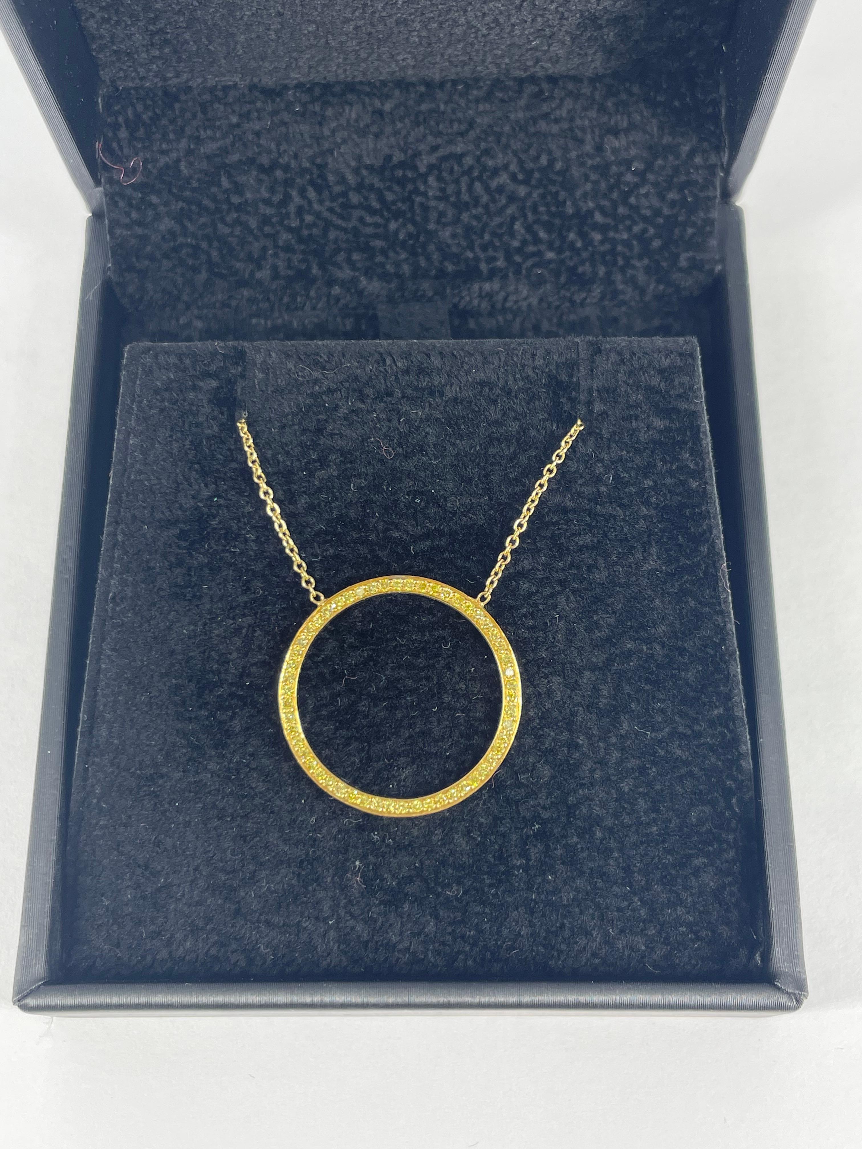 This sophisticated piece by J. Birnbach is a sleek open circle with 0.43 carats fancy intense yellow diamonds. The pendant is attached to the chain so it will always lay flat and straight on the wearer. The pendant and chain are crafted in 18K