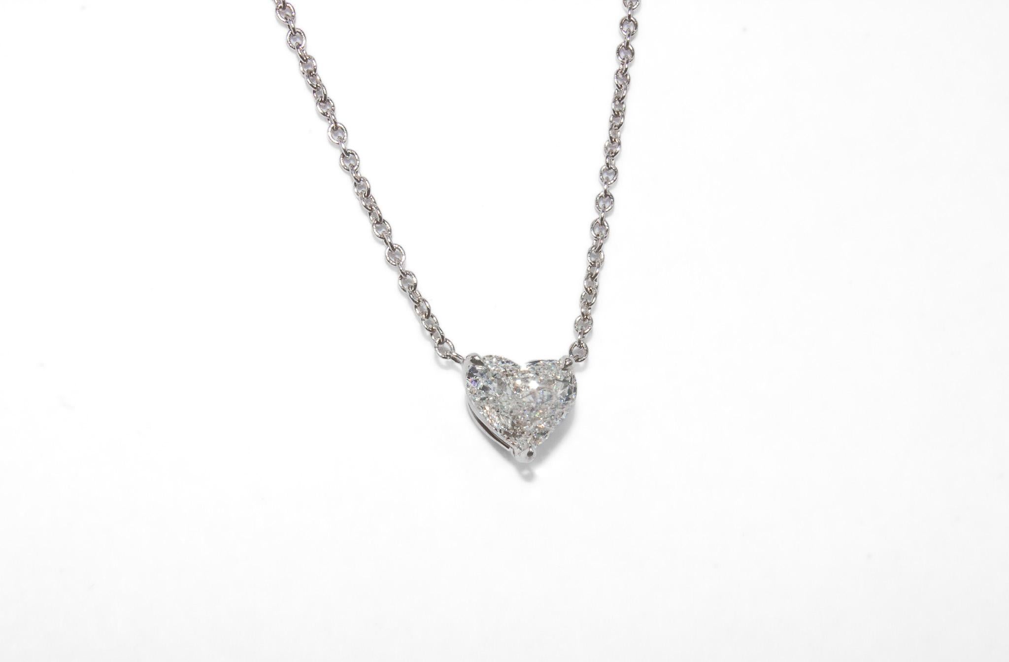 This timeless 18K white gold solitaire pendant necklace showcases a stunning 0.44 carat heart-shaped diamond, graded D in color and SI2 in clarity. The diamond’s exceptional brilliance and romantic heart shape make this piece both elegant and