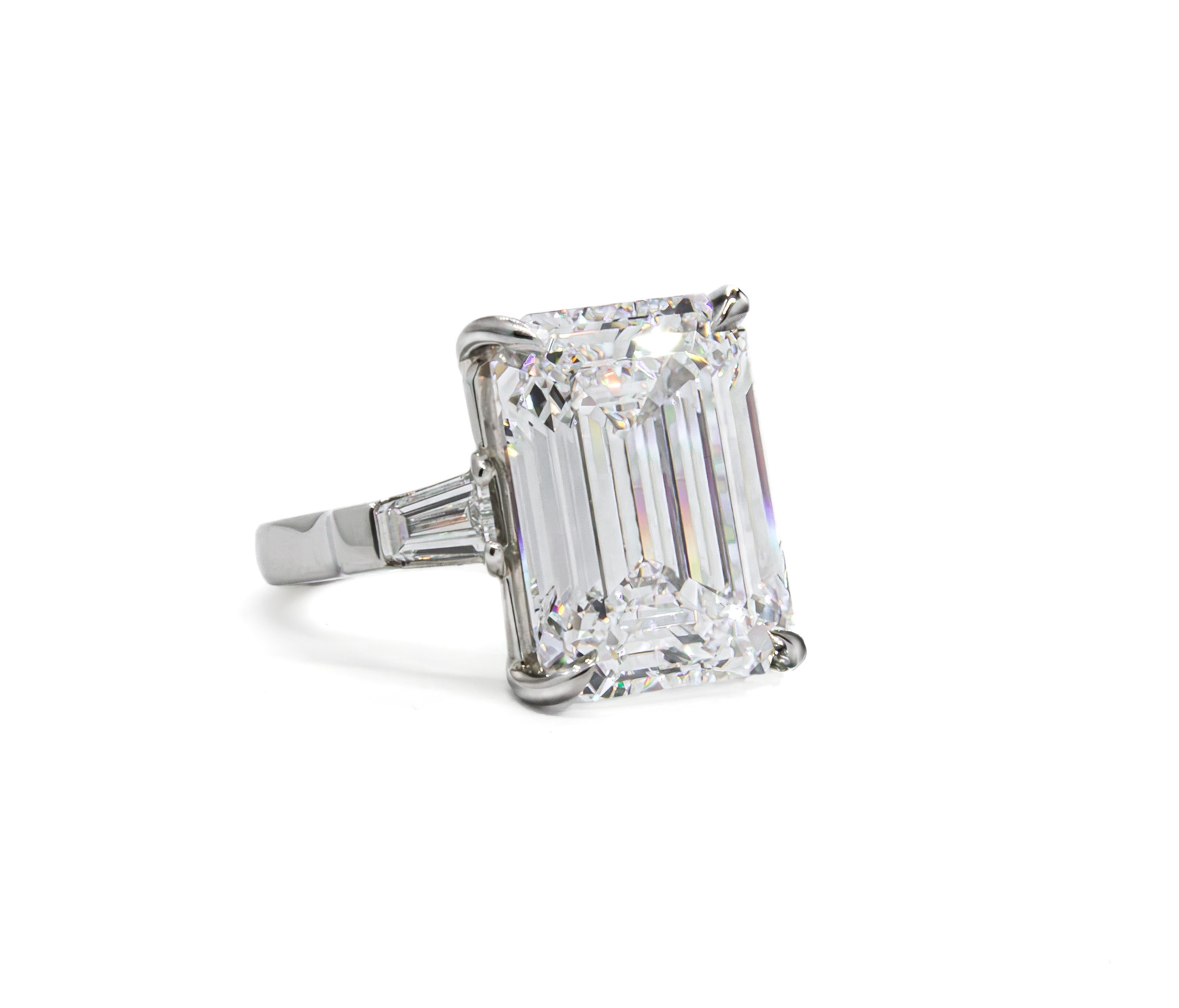 A true collector’s treasure, this platinum three-stone ring showcases a breathtaking 13.09 carat emerald cut diamond, graded D color and Flawless clarity by GIA—representing the highest possible grading on both scales. Exceptionally rare, this