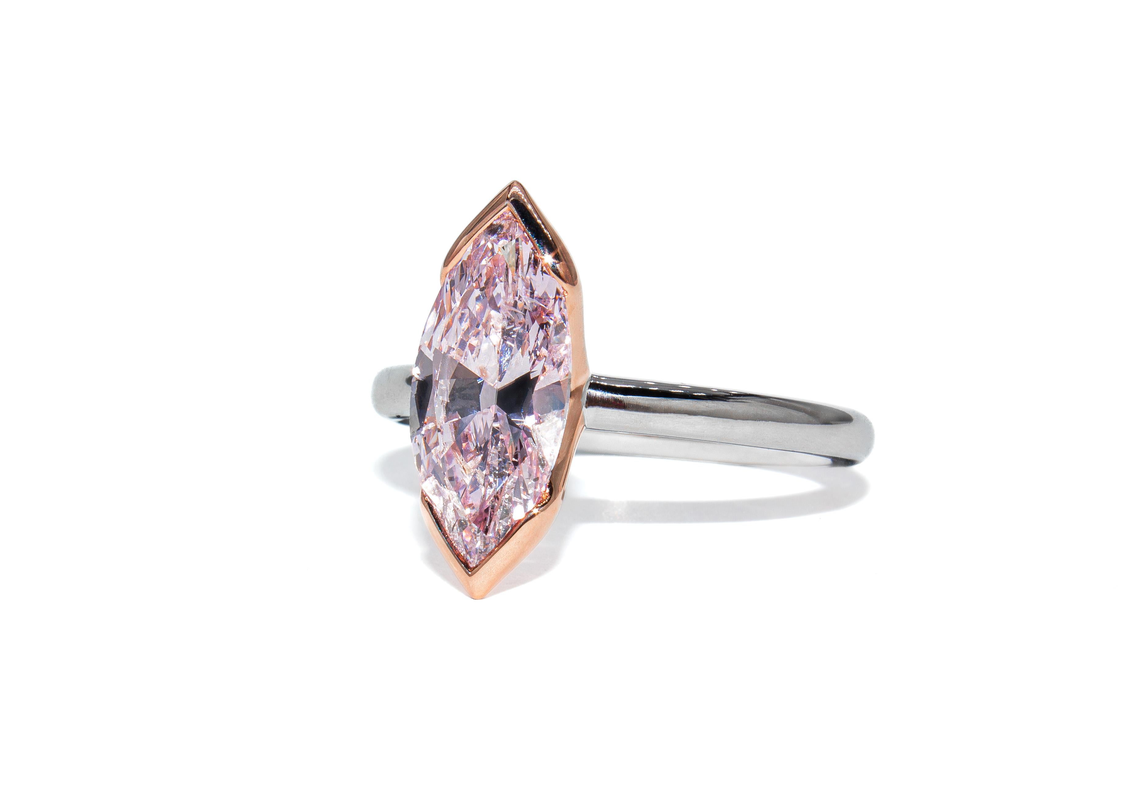 This exceptional two-tone solitaire ring features a rare and captivating 2.03 carat marquise cut diamond, certified by GIA as Fancy Purple-Pink in color. Set in a harmonious blend of 18K rose gold and platinum, the design highlights the vibrant hue