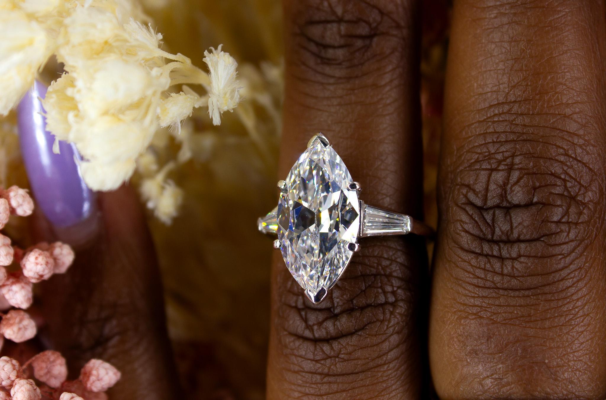 Celebrate timeless elegance with this J. Birnbach GIA Certified Antique Marquise Diamond Three-Stone Ring, a captivating piece that embodies classic sophistication. The centerpiece of this remarkable ring is a 5.51 carat antique marquise-cut