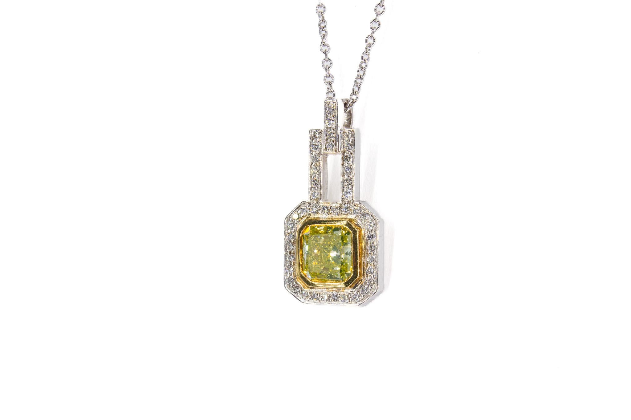 Add a touch of radiant elegance to your collection with this exquisite pendant necklace. The centerpiece is a stunning 0.95 carat radiant cut fancy 
 intense greenish yellow diamond, certified by GIA with exceptional VVS2 clarity, ensuring its