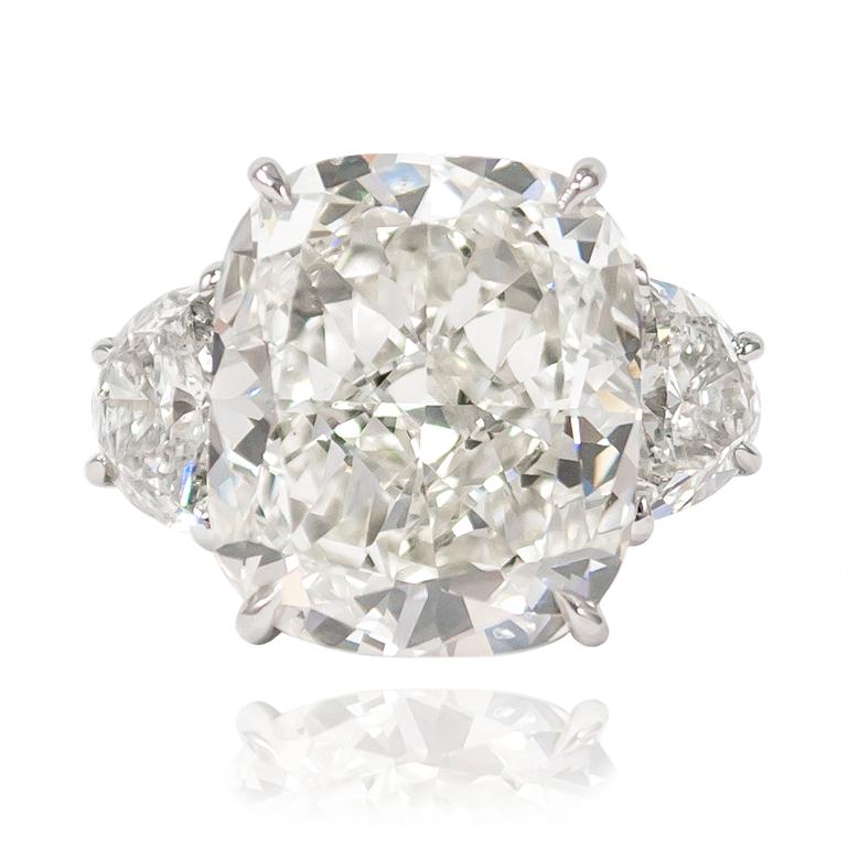 This incredible J. Birnbach original features a 10.01 carat Cushion Modified Brilliant diamond... Set in a handmade, platinum mounting with a pair of half moon side stones, this ring is elegant and sophisticated in every way. 

Purchase includes