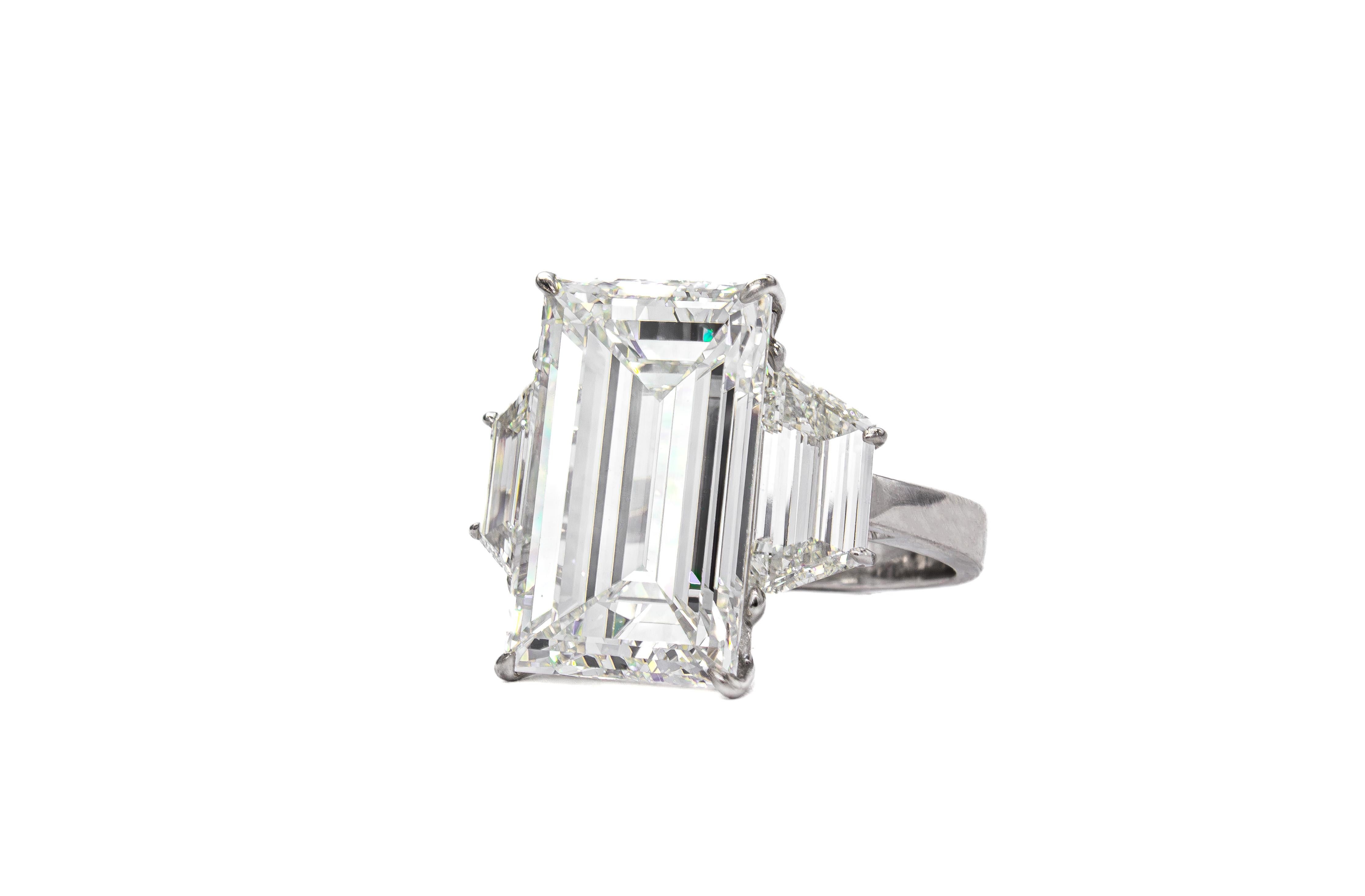 An extraordinary masterpiece of craftsmanship and rarity, this platinum three-stone ring showcases a breathtaking 10.02 carat emerald cut diamond, GIA certified G color, VS2 clarity. Stones of this remarkable size, quality, and balance are